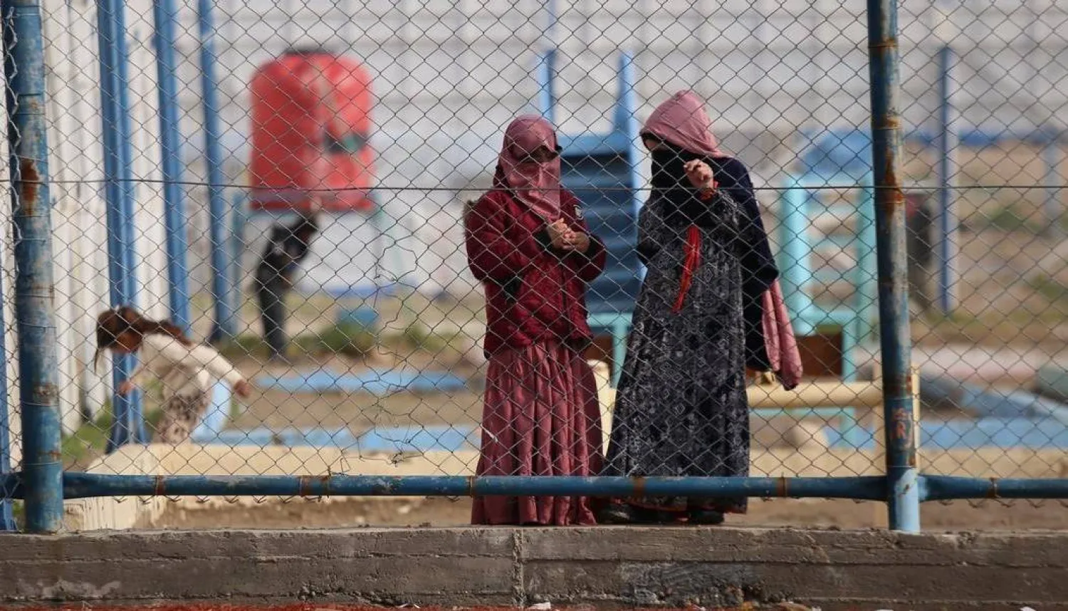 اثنتان من زوجات عناصر «داعش» خلف أسوار مخيم «روج» شمال شرقي سوريا (أ.ب)