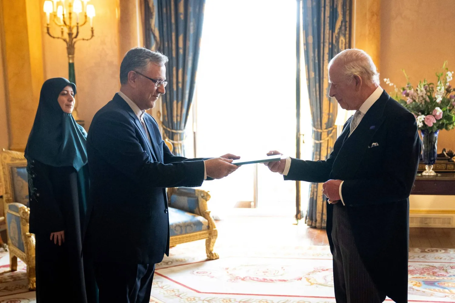 Ambassador from Iran, Seyed Ali Mousavi (2nd L), meets Britain's King Charles III during an audience at Buckingham Palace in London on June 12, 2025. (AFP)