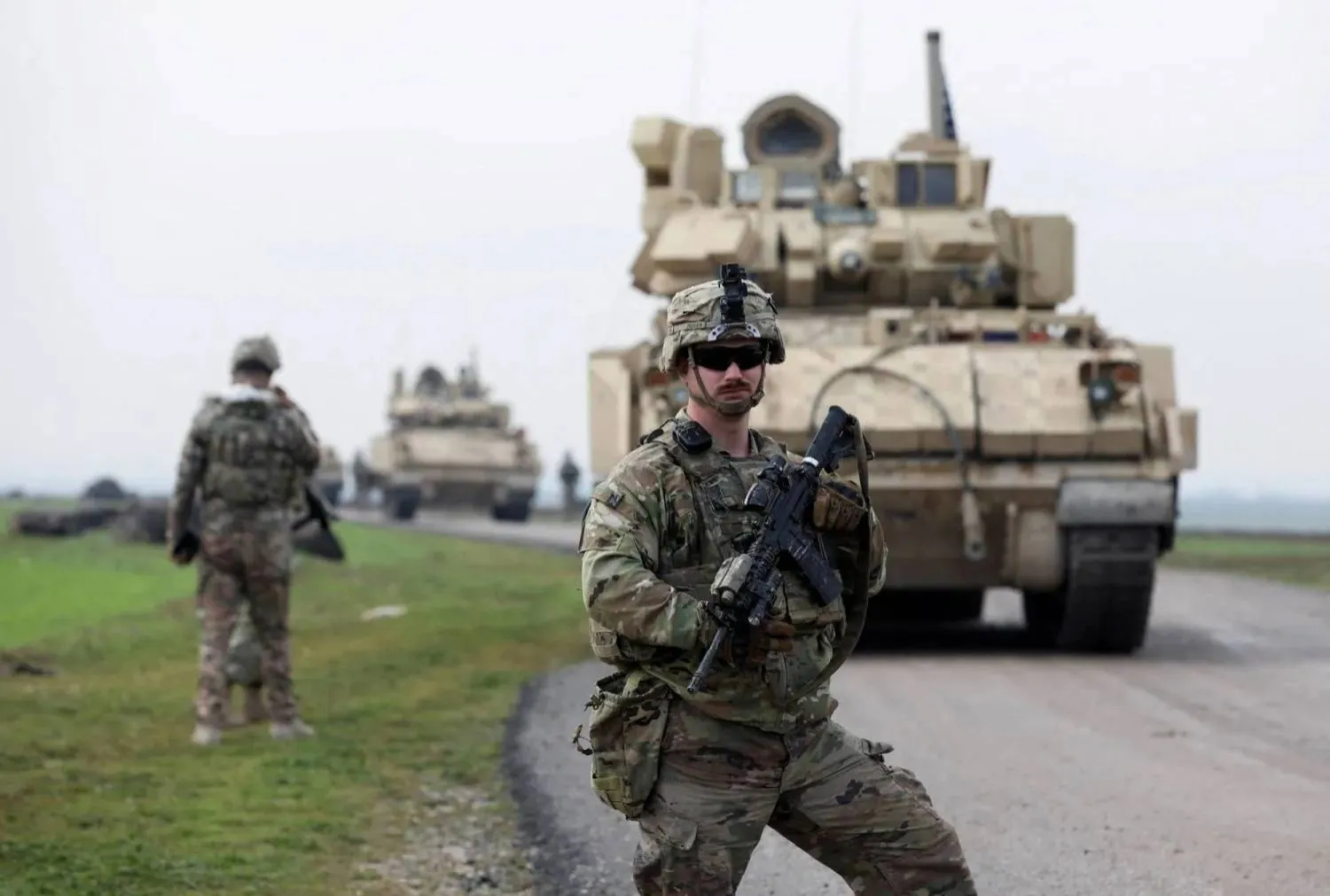 A soldier from the US-led coalition stands guard during a joint US- Kurdish-led Syrian Democratic Forces (SDF) patrol in the countryside of Qamishli in northeastern Syria February 8, 2024. (Reuters) 