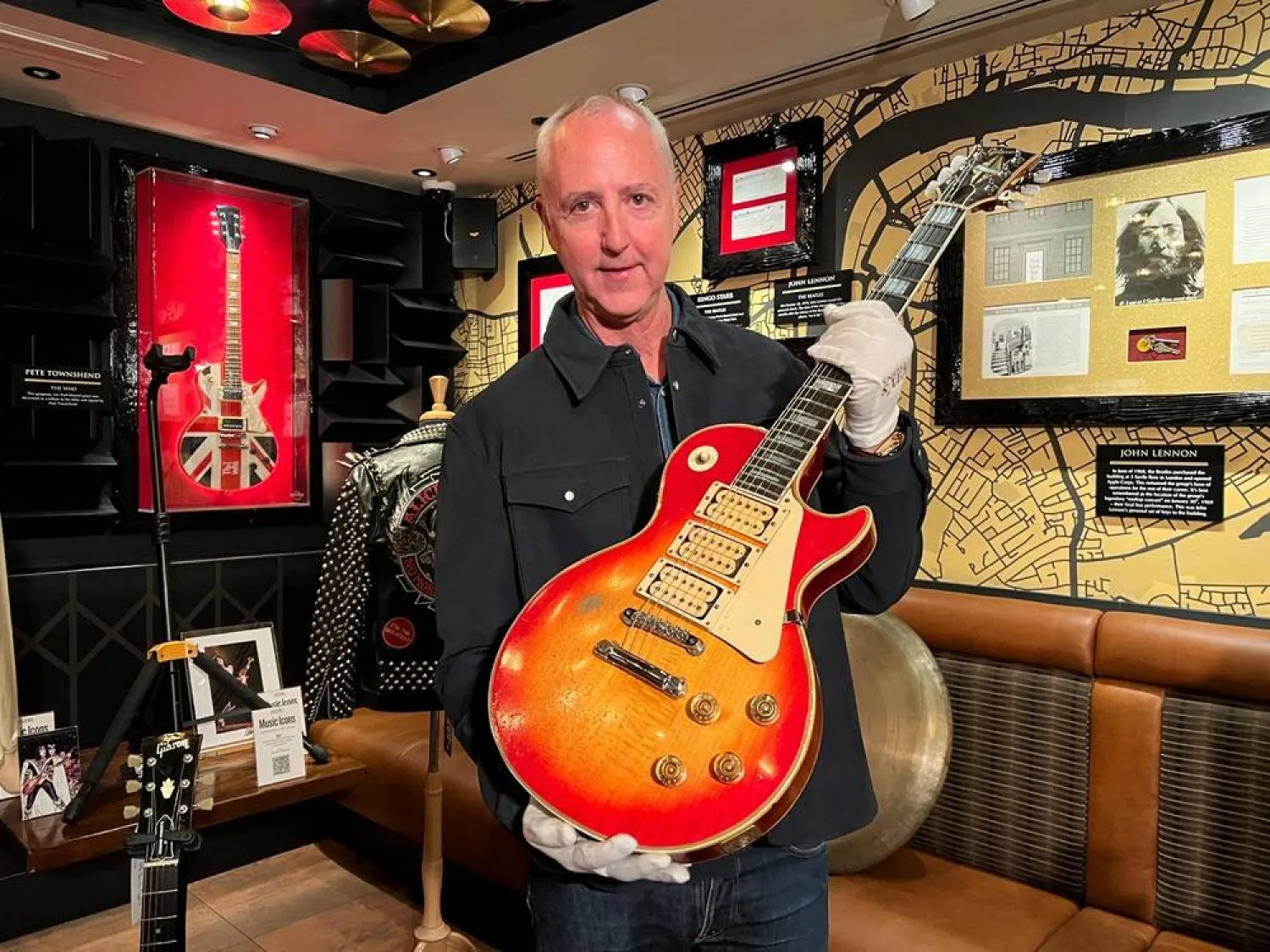  Executive director and Co-founder of Julien's Auctions Martin Nolan poses with Kiss original lead guitarist Ace Frehley's #1 1974 "Budokan" Triple Pickup Gibson Les Paul Custom, Cherry Sunburst guitar at the Hard Rock Cafe Piccadilly Circus, in London, Britain, March 24, 2026. (Reuters)