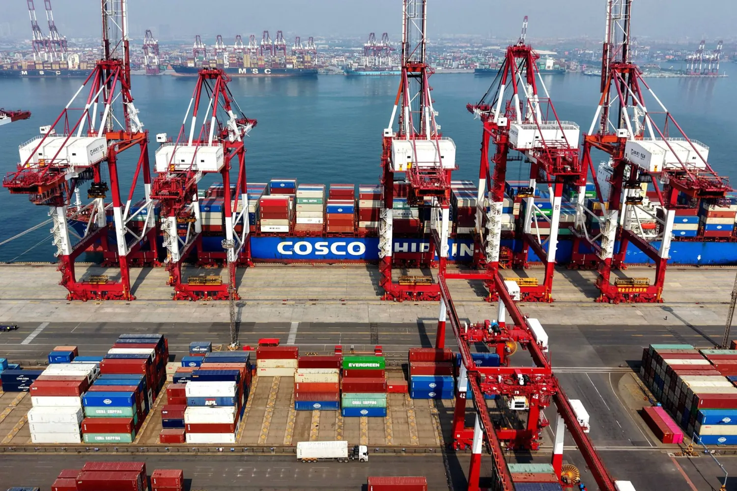 A cargo ship operated by Cosco Shipping is docked at the foreign trade container terminal of Qingdao Port, operated by Shandong Port Group, in China's eastern Shandong province on March 25, 2026. (Photo by CN-STR / AFP)