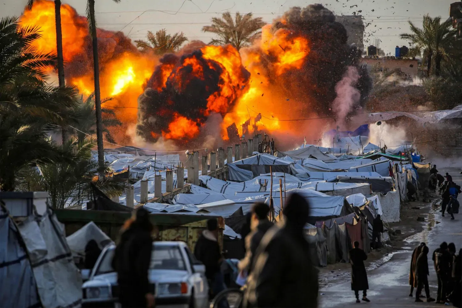 İsrail’in dün düzenlediği saldırının ardından Gazze Şeridi’nin orta kesimindeki Deyr el-Balah’ta bulunan bir mülteci kampından alevler yükseliyor. (AFP)