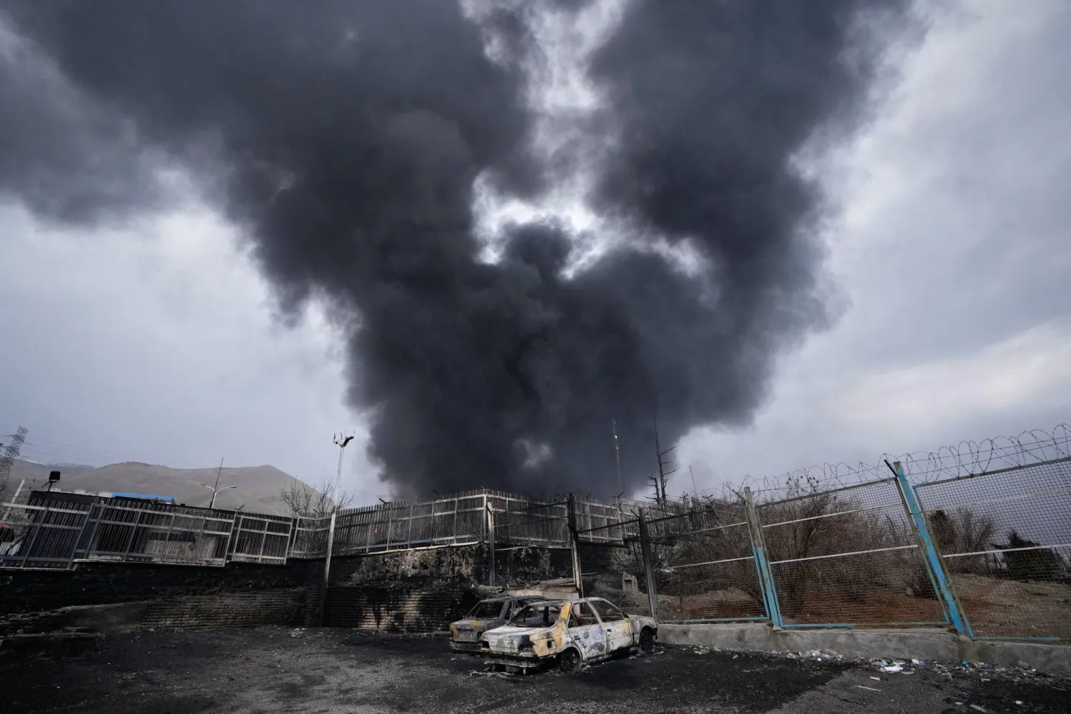 FILE - A thick plume of smoke rises from an oil storage facility hit by a US-Israeli strike in Tehran, Iran, March 8, 2026. (AP Photo/Vahid Salemi, File)