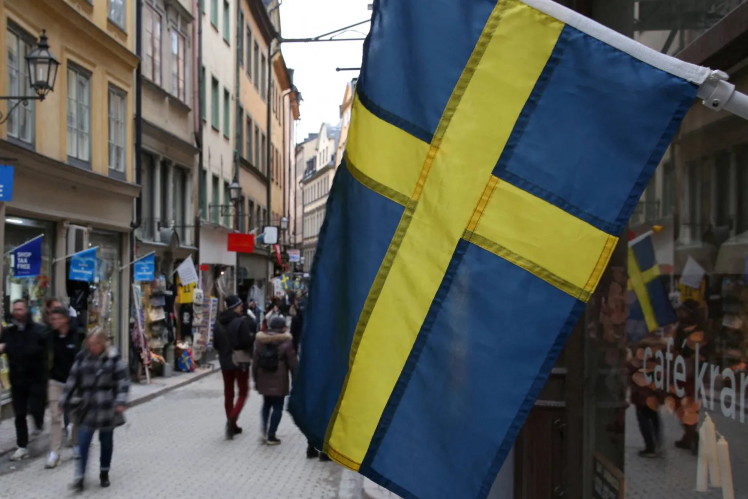 FILE PHOTO: A Swedish flag hangs outside a business on a street of the old city of Stockholm, Sweden, February 24, 2024. REUTERS/Tom Little/File Photo