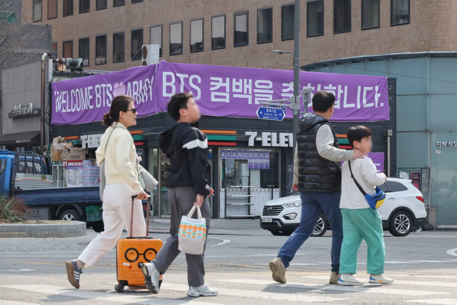 People walk near Gwanghwamun Square in Seoul, South Korea, 22 March 2026. The band performed their comeback concert on 21 March.  EPA/YONHAP