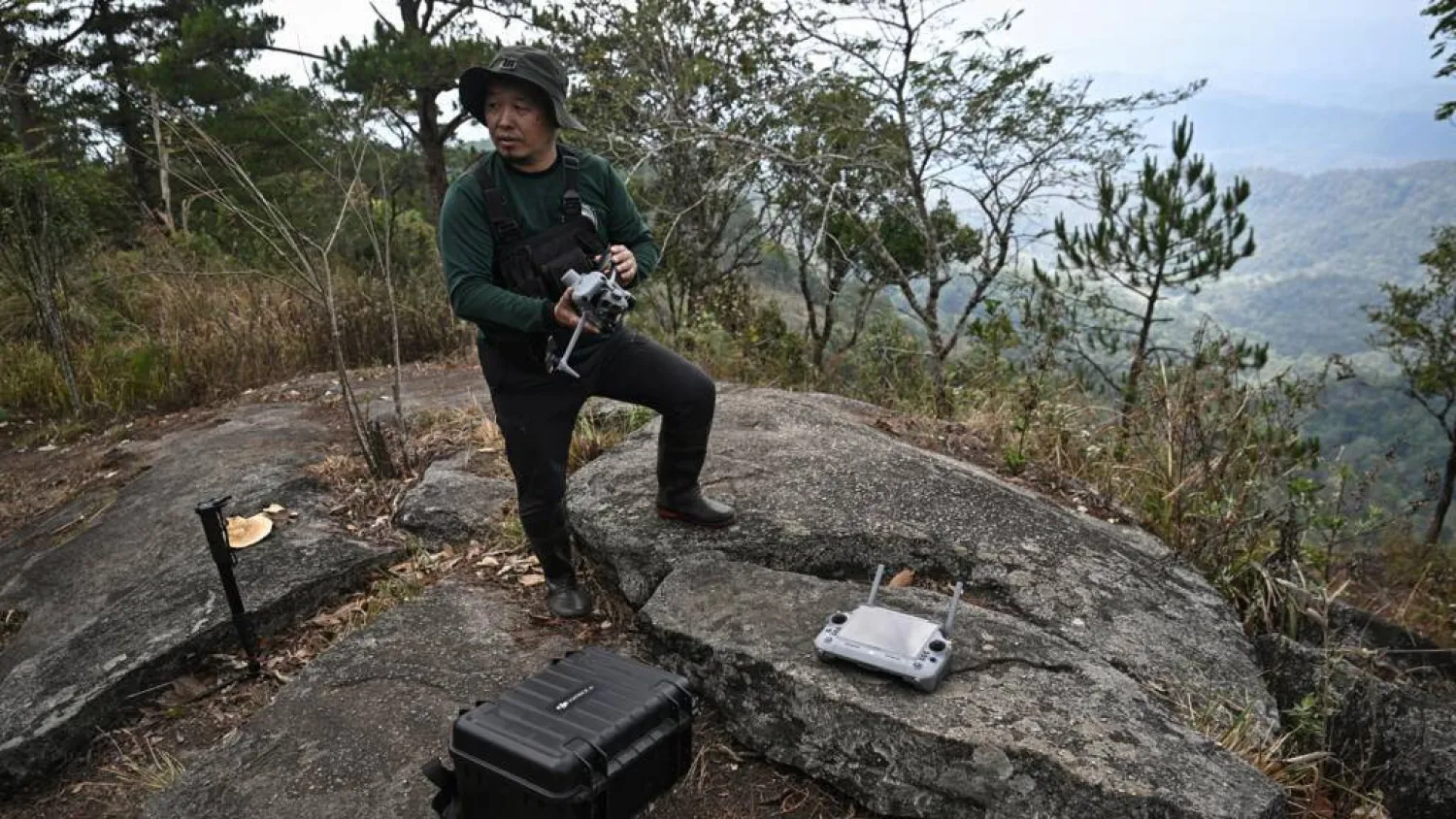 Hmong volunteer firefighter Mongkol Yingyotmongkolsaen using a drone to monitor fires in the Doi Suthep-Pui National Park area of Chiang Mai. Lillian SUWANRUMPHA / AFP
