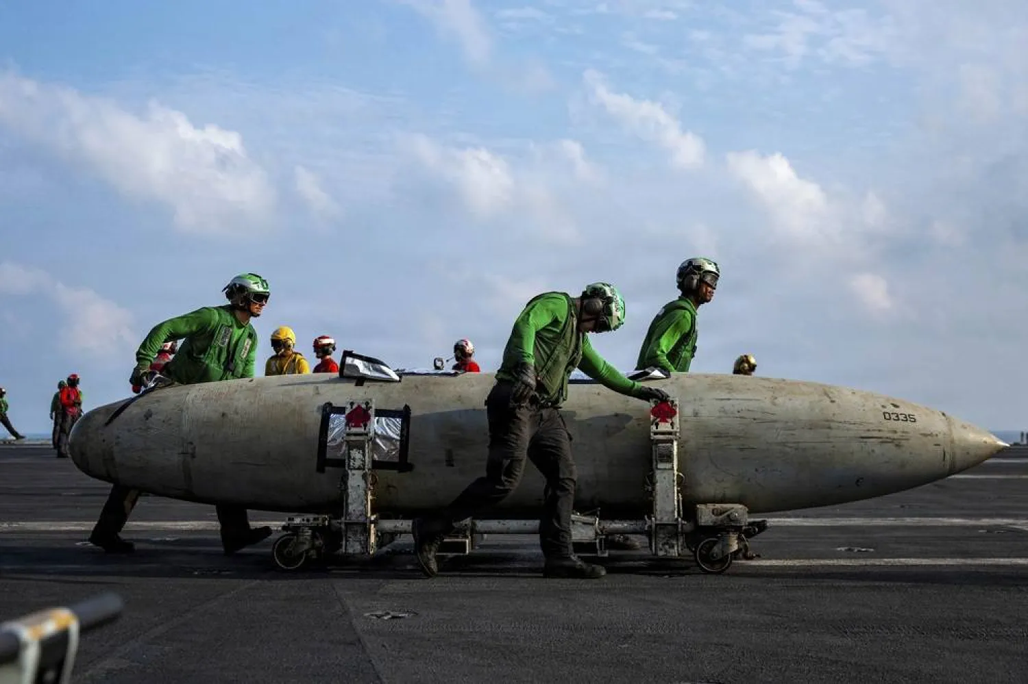 21 March 2026, ---: US Navy sailors move a F/A-18 fighter aircraft fuel tank on the flight deck of the Nimitz-class aircraft carrier USS Abraham Lincoln during Operation Epic Fury, from an undisclosed location. (US Navy via Planet Pix via ZUMA Press Wire/dpa) 