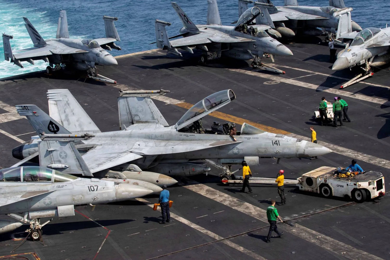 US Navy sailors taxi an F/A-18F Super Hornet on the flight deck aboard Nimitz-class aircraft carrier USS Abraham Lincoln in support of the Operation Epic Fury attack on Iran from an undisclosed location March 17, 2026. (US Navy/Handout via Reuters) 