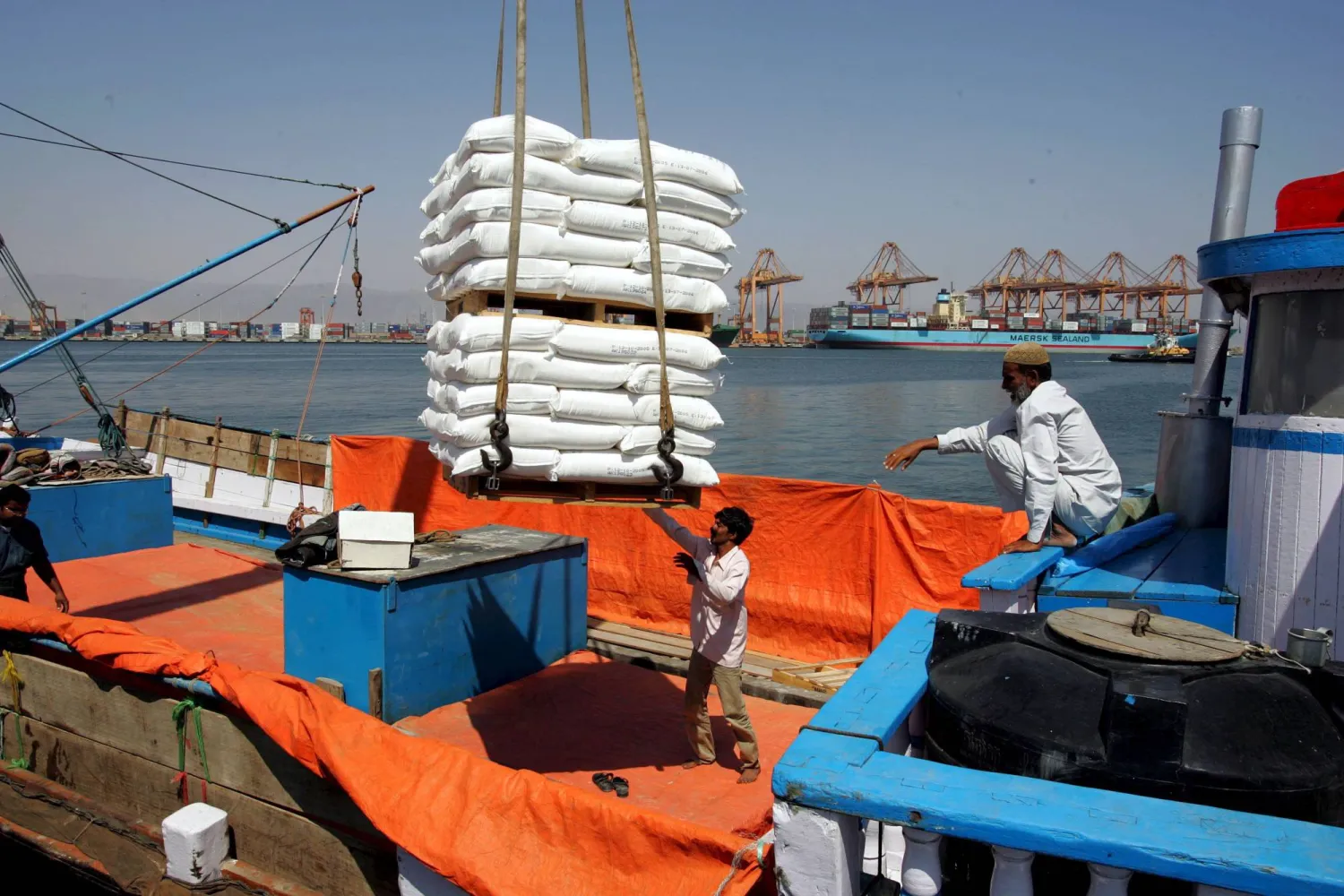 (FILE) - An Indian dhow captain supervises the loading of Omani refined flour aboard a dhow destined for India at the container port of Salalah, Oman, 24 October 2005 (reissued 20 March 2026). EPA/MIKE NELSON 