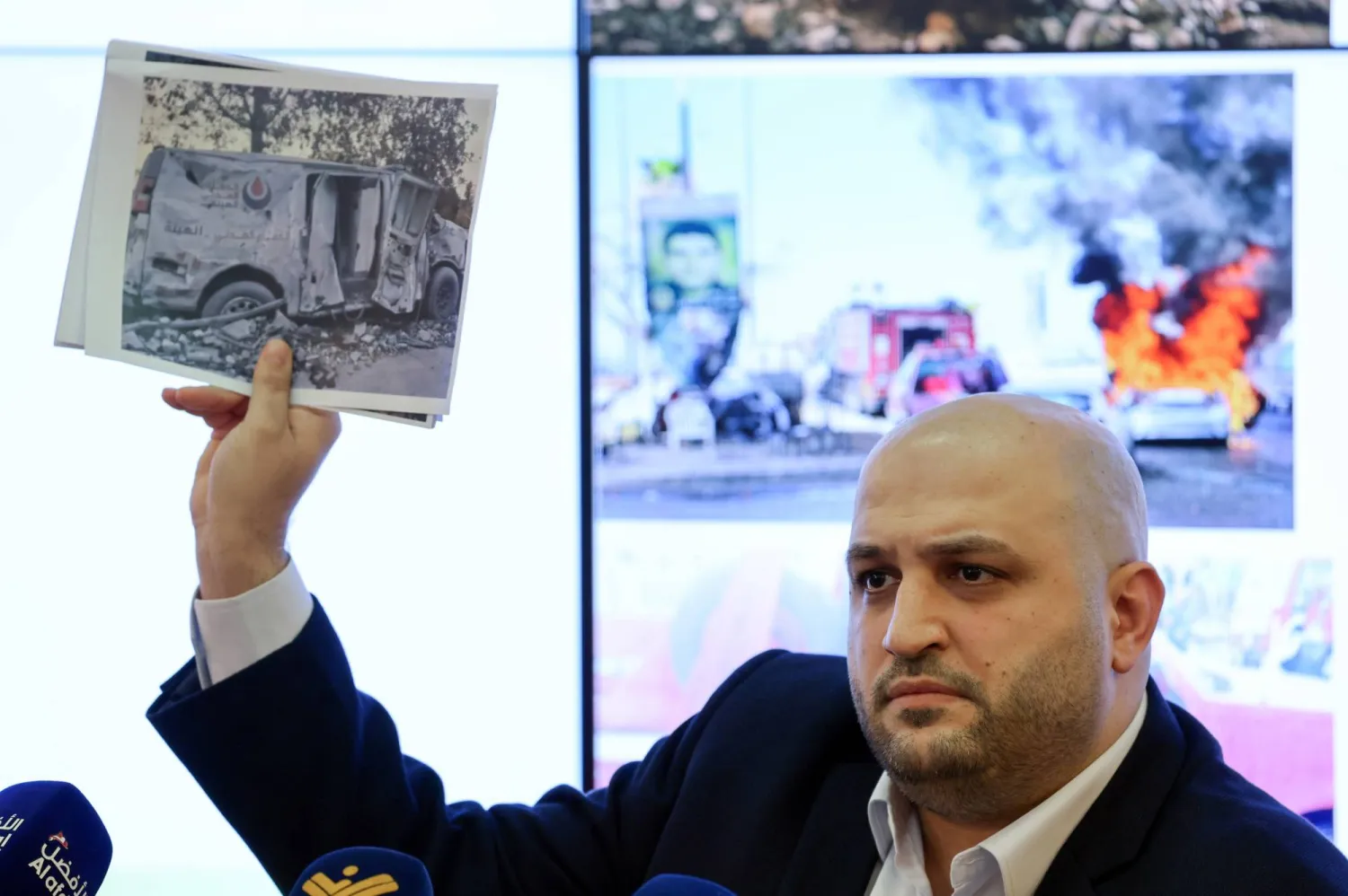 Lebanese Minister of Health Rakan Nassereddine holds up a picture of an ambulance damaged in an Israeli air strike during a press conference at the Ministry of Health in Beirut, Lebanon, 28 March 2026. EPA/WAEL HAMZEH