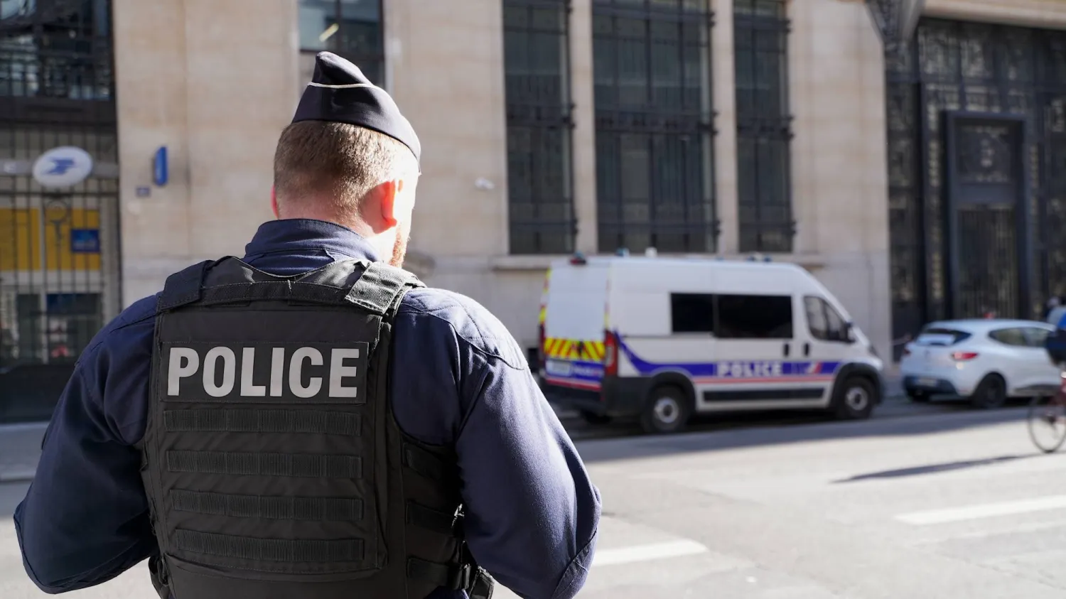 Police stand outside the Bank of America building in Paris, Saturday, March 28, 2026. (AP)
