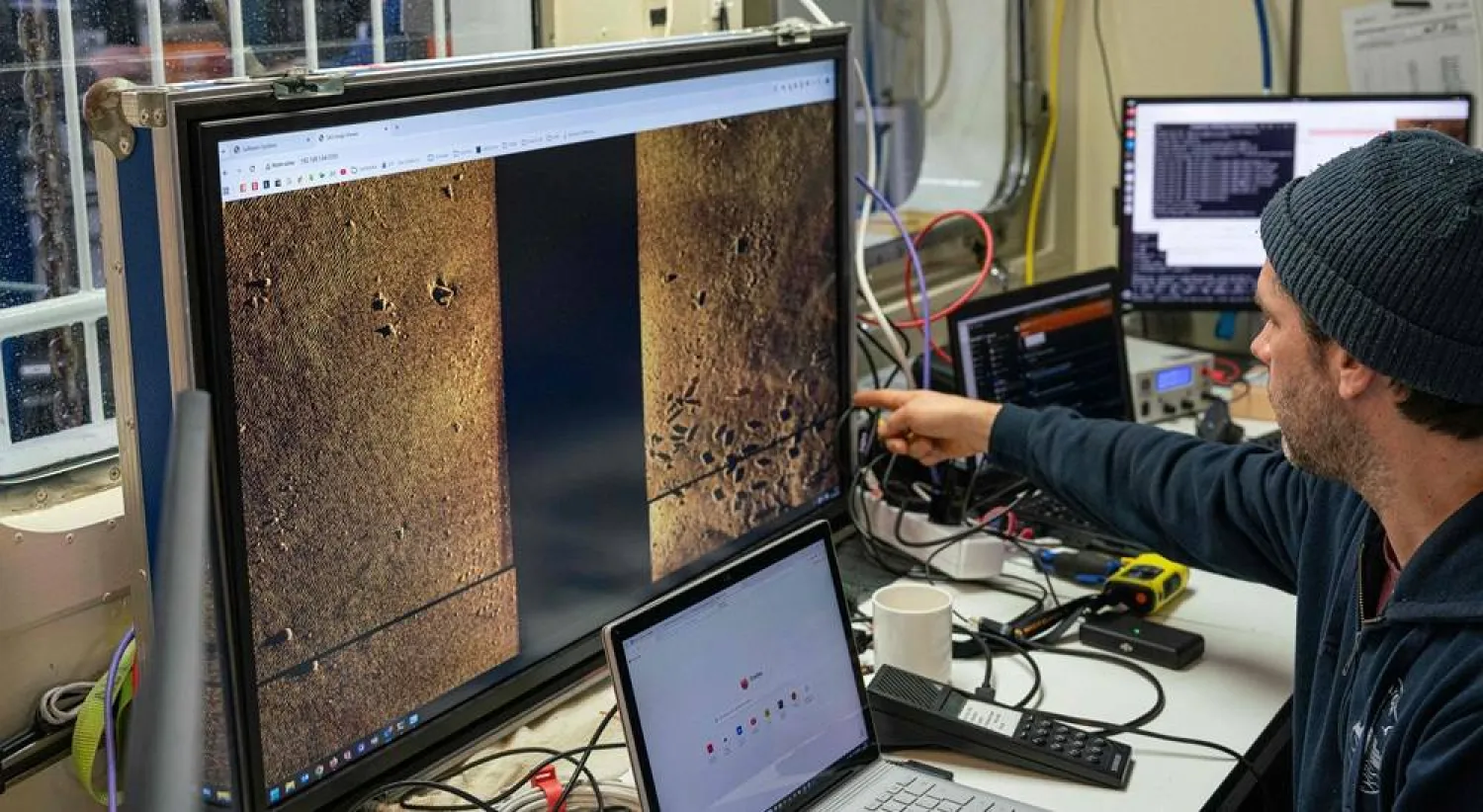 This handout photo taken on March 16, 2026 and released by the Kiel-based GEOMAR oceanographic research center on March 23, 2026 shows a scientist looking at digital scans highlighting munitions and various spots of interest on the seabed aboard the scientific research vessel Alkor in the Eastern Baltic Sea. (Lauren Peck / GEOMAR / AFP) 