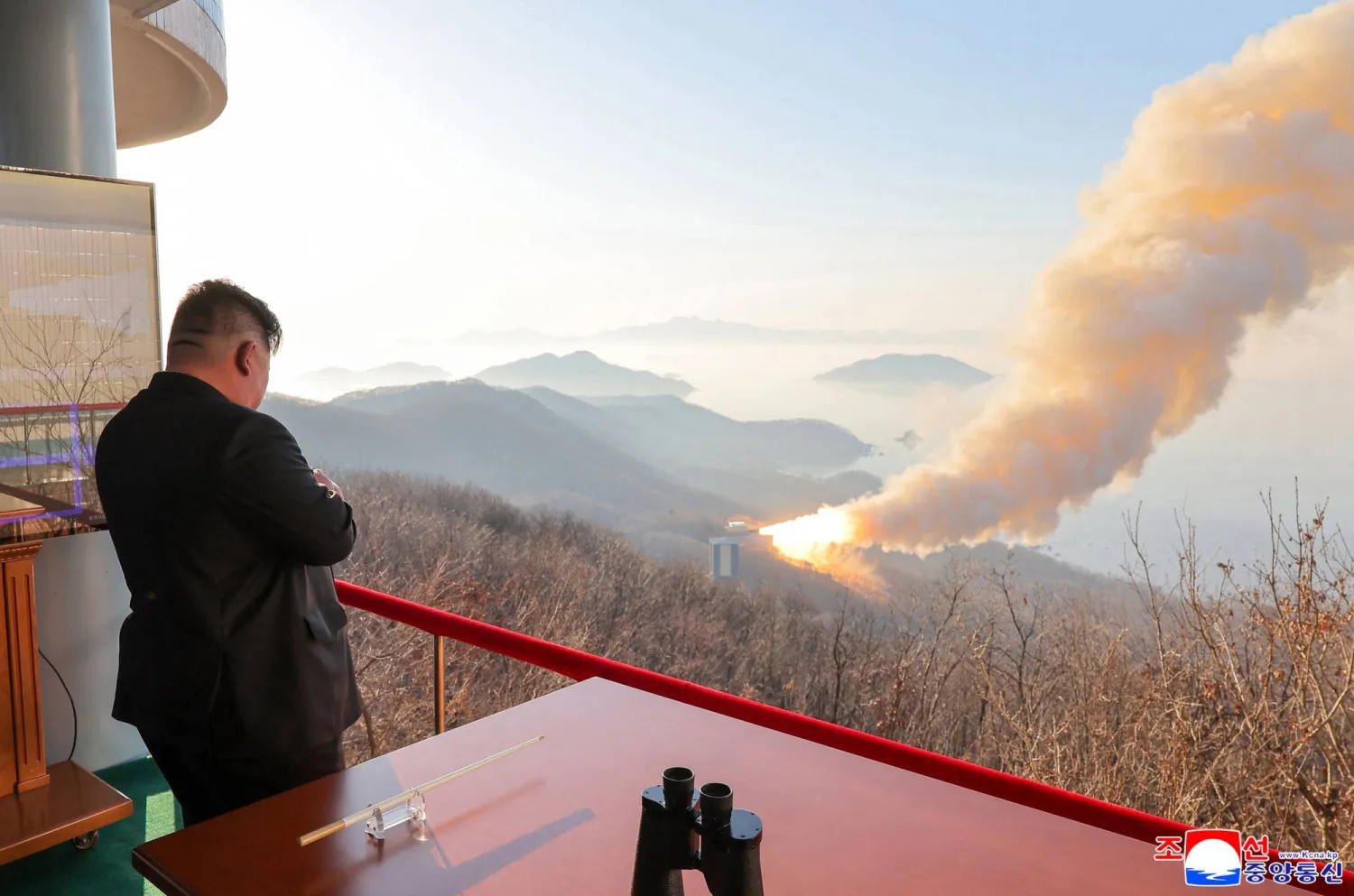 This undated picture released by North Korea's official Korean Central News Agency (KCNA) on March 29, 2026 shows North Korean leader Kim Jong Un inspecting a combustion test of a solid-fuel rocket engine at an undisclosed location in North Korea. (KCNA via KNS / AFP) 