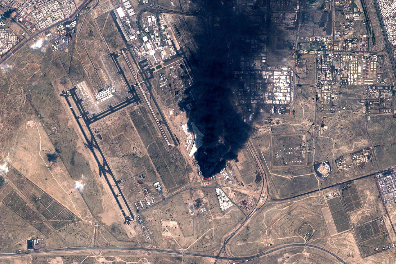 This handout image taken by the European Space Agency (ESA) captured by the Copernicus Sentinel-2 satellite shows a view of smoke plumes billowing in the vicinity Kuwait International Airport on March 25, 2026. (Photo by EUROPEAN SPACE AGENCY / AFP) 