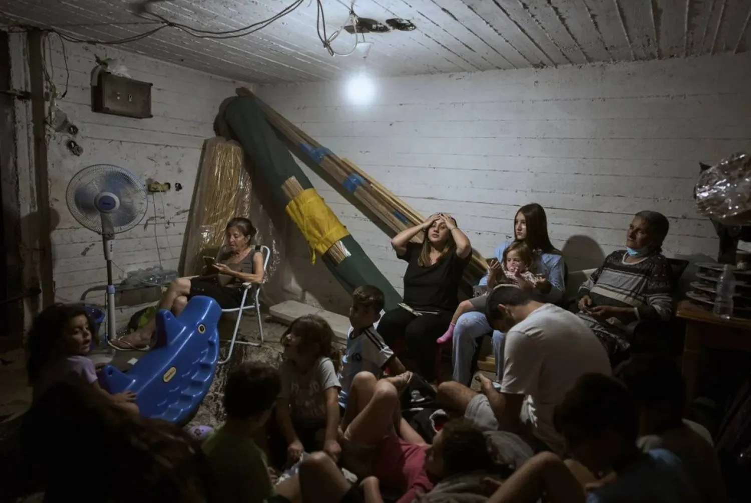 Israelis take shelter during air raid sirens warning of incoming strikes by Iran, in Bnei Brak, near Tel Aviv, Israel, Tuesday, June 17, 2025. (AP Photo/Oded Balilty)