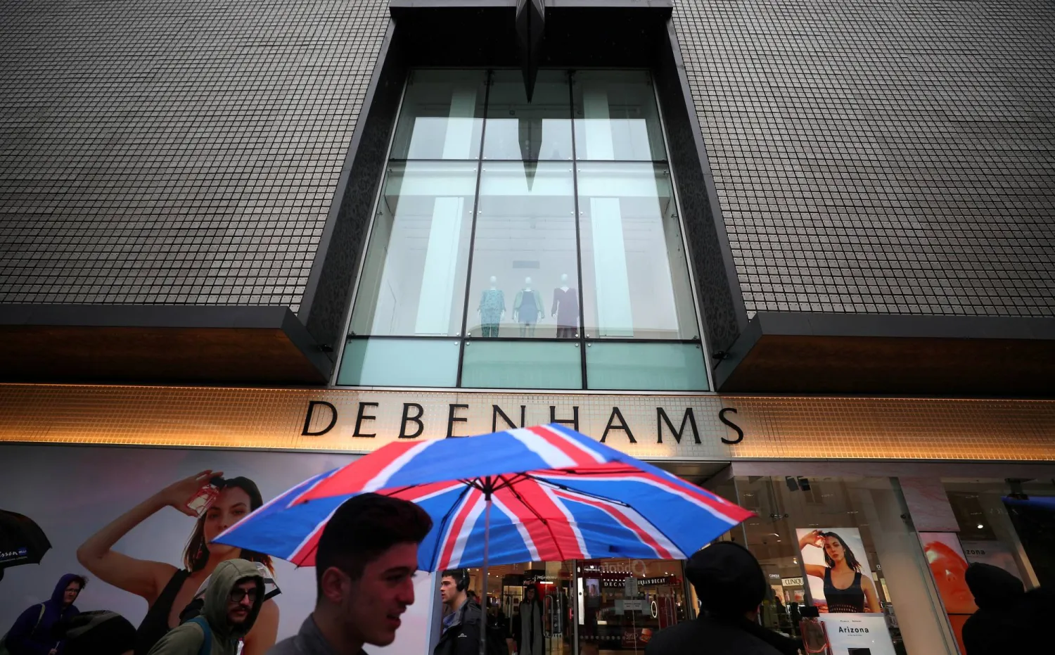 FILE PHOTO: Shoppers walk past Debenhams on Oxford Street in central London, Britain, April 2, 2018. REUTERS/Hannah McKay/File Photo