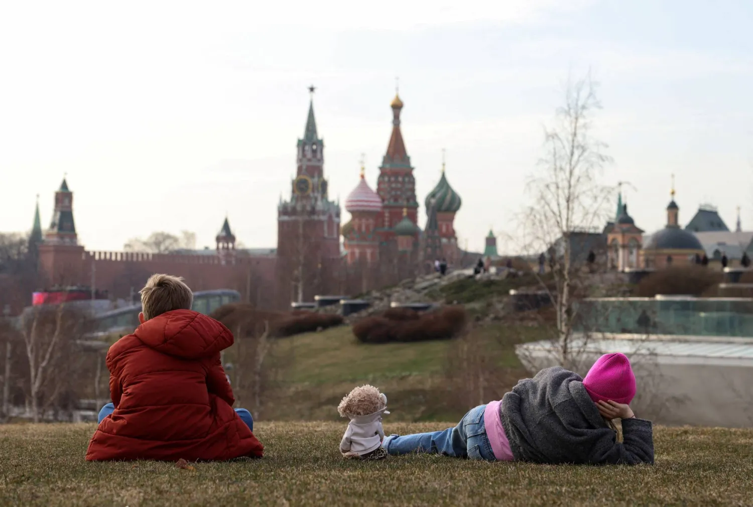 Children enjoy warm day in Zaryadye Park with Kremlin and St. Basil’s Cathedral in the background, in Moscow, Russia March 27, 2026.  REUTERS/Anastasia Barashkova