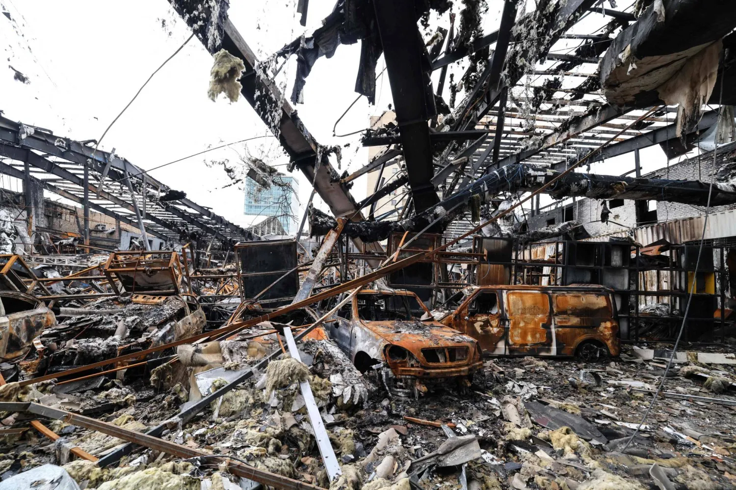 A photograph shows the damage during the visit of a car service center in eastern Tehran that was hit by a missile strike, on March 28, 2026. (Photo by ATTA KENARE / AFP)