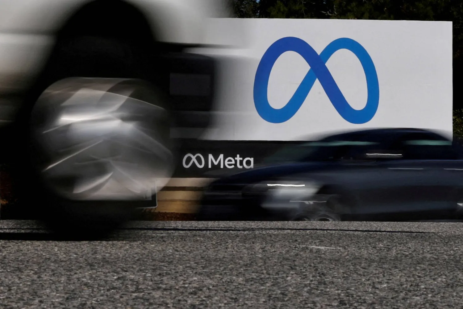 Cars drive past a sign of Meta, the new name for the company formerly known as Facebook, at its headquarters in Menlo Park, California, US, October 28, 2021. (Reuters)