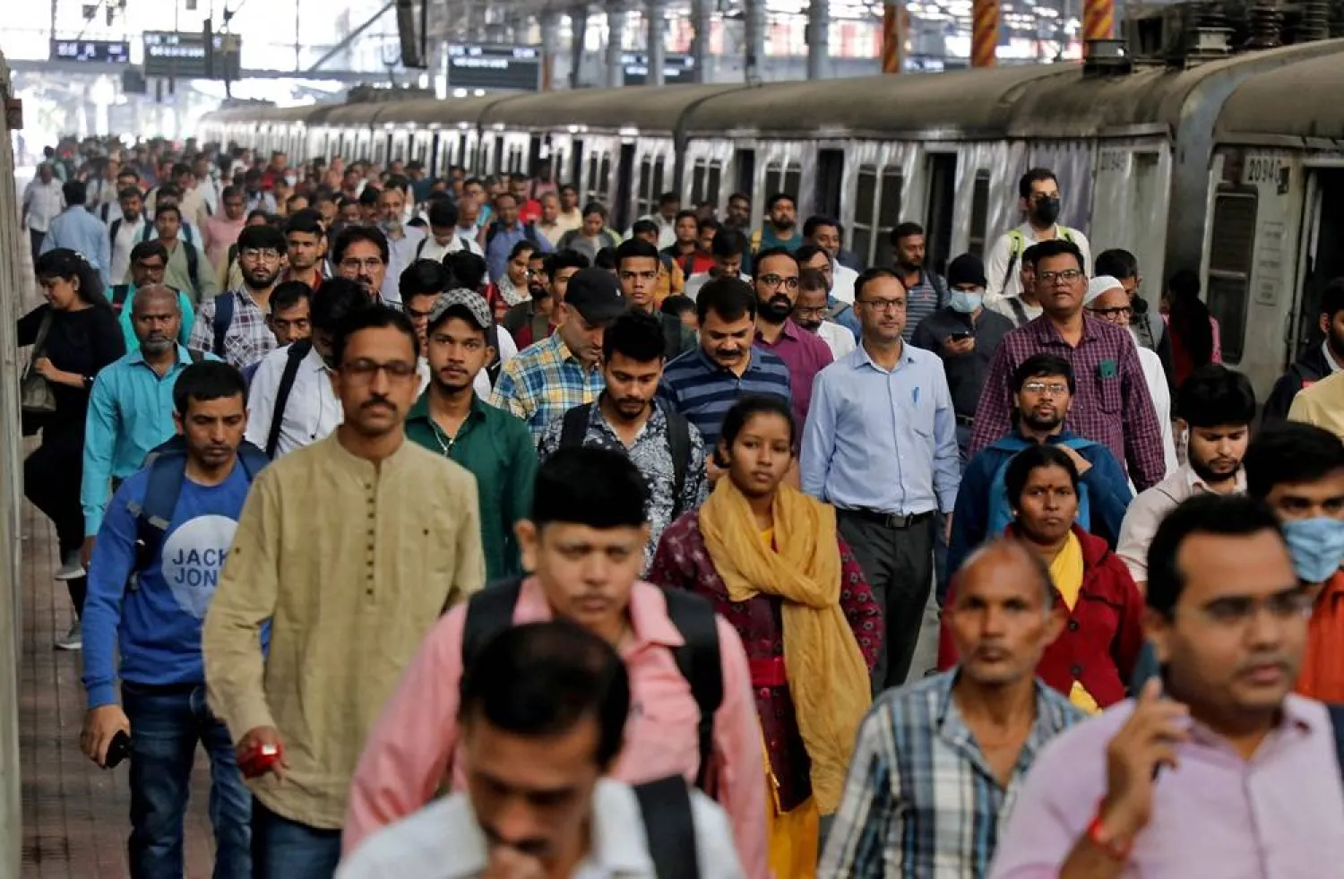 Commuters walk on a platform after disembarking from a suburban train at a railway station in Mumbai, India, January 21, 2023. (Reuters)