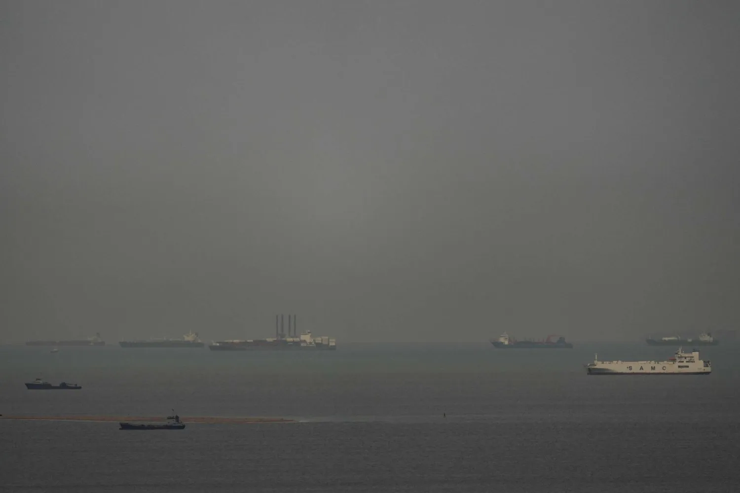 سفن شحن تبحر عبر الخليج العربي كما تُرى من عجمان بالإمارات العربية المتحدة (أ.ب)