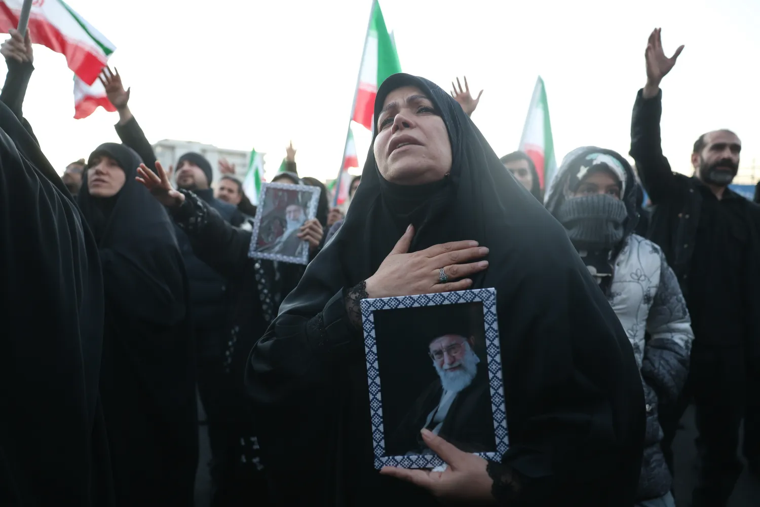 Mourners hold pictures of Iranian Supreme Leader Ali Khamenei following his death; at Enqelab Square in Tehran, Iran, 01 March 2026. (EPA)