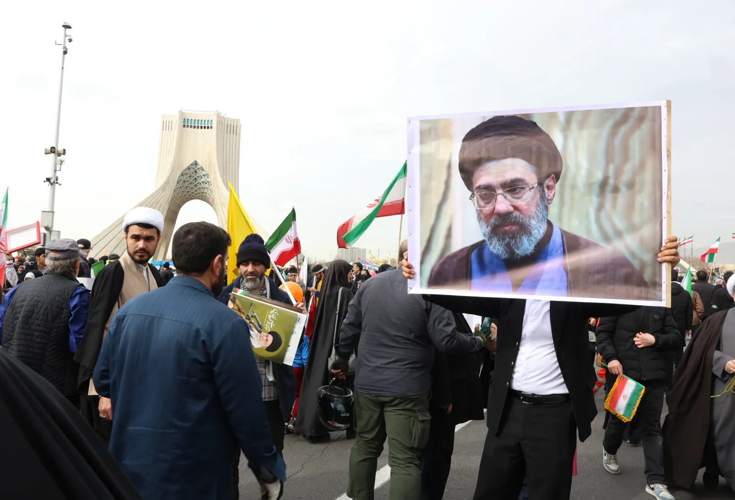 An Iranian man holds a portrait of Mojtaba Khamenei, son of the late Supreme Leader Ali Khamenei, during the 47th anniversary celebrations of the revolution in Tehran, Iran, 11 February 2026. (EPA) 