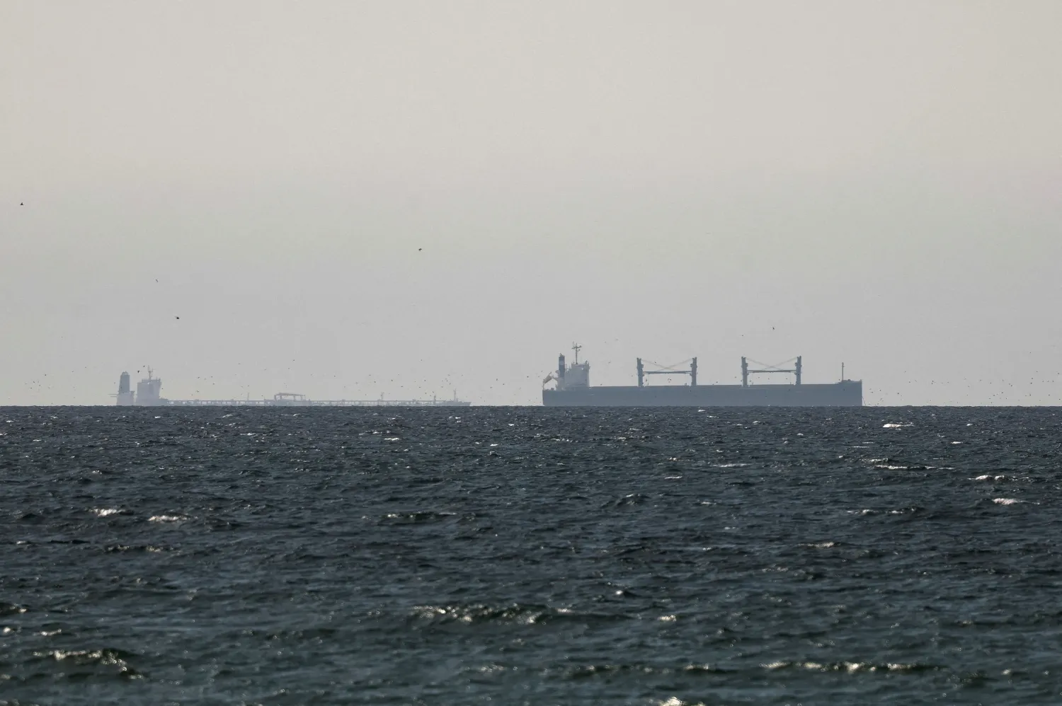 A cargo ship in the Gulf, near the Strait of Hormuz, as seen from northern Ras al-Khaimah, near the border with Oman’s Musandam governance, amid the US-Israeli conflict with Iran, in United Arab Emirates, March 11, 2026. REUTERS/Stringer