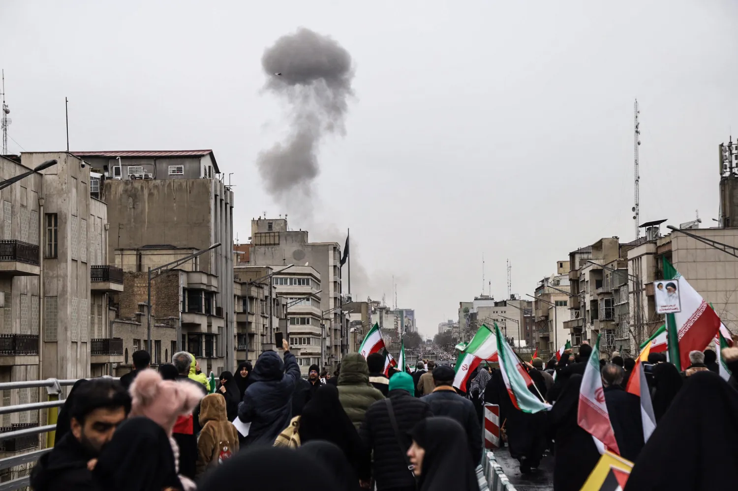 Black smoke rises following an airstrike, as Iranians take part in the Al-Quds (Jerusalem) Day rally, a commemoration in support of the Palestinian people on the last Friday of the Islamic holy month of Ramadan, in Tehran on March 13, 2026. (AFP)