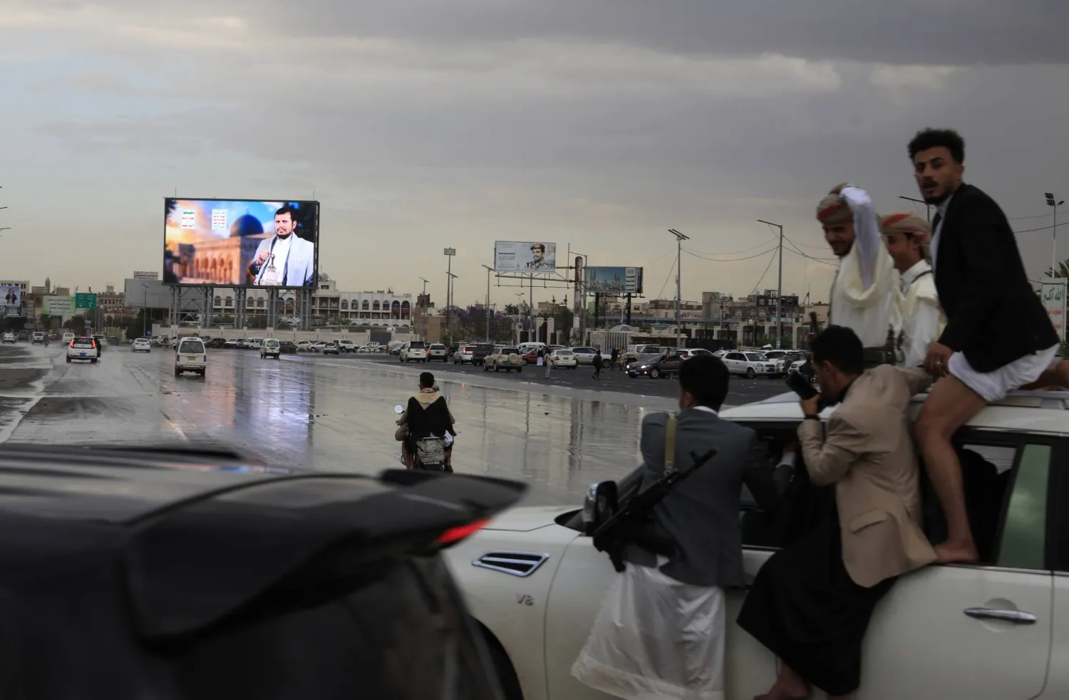 People ride in a vehicle past a digital billboard featuring Houthi leader Abdul-Malik al-Houthi in Sanaa, Yemen, 31 March 2026. EPA/YAHYA ARHAB