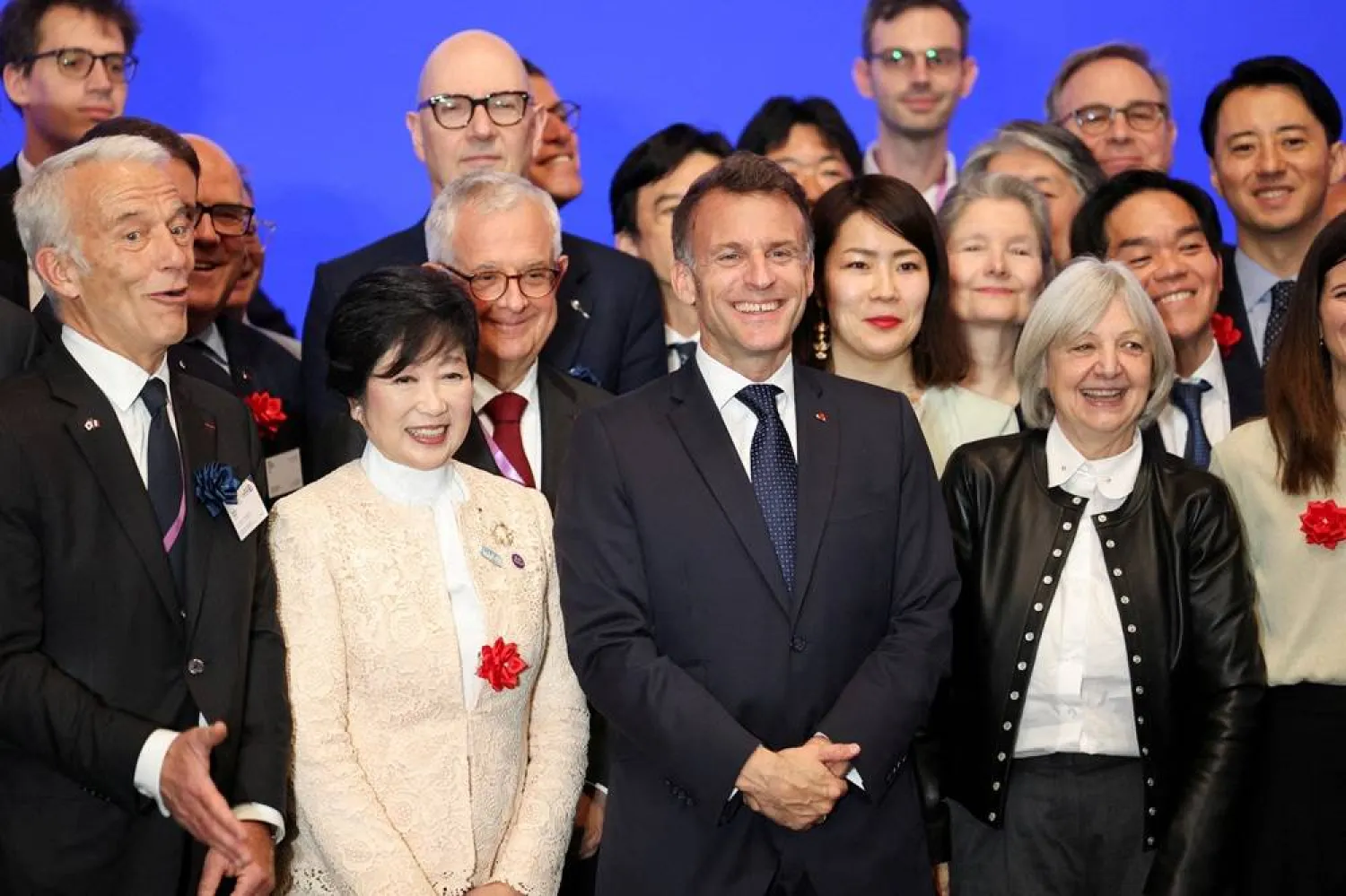  French President Emmanuel Macron poses with the Governor of Tokyo Yuriko Koike, Mouvement des Entreprises de France (MEDEF) President Patrick Martin and other attendees, at an economic forum on cooperation between France and Japan in strategic fields, in Tokyo, Japan, April 1, 2026. (Reuters)