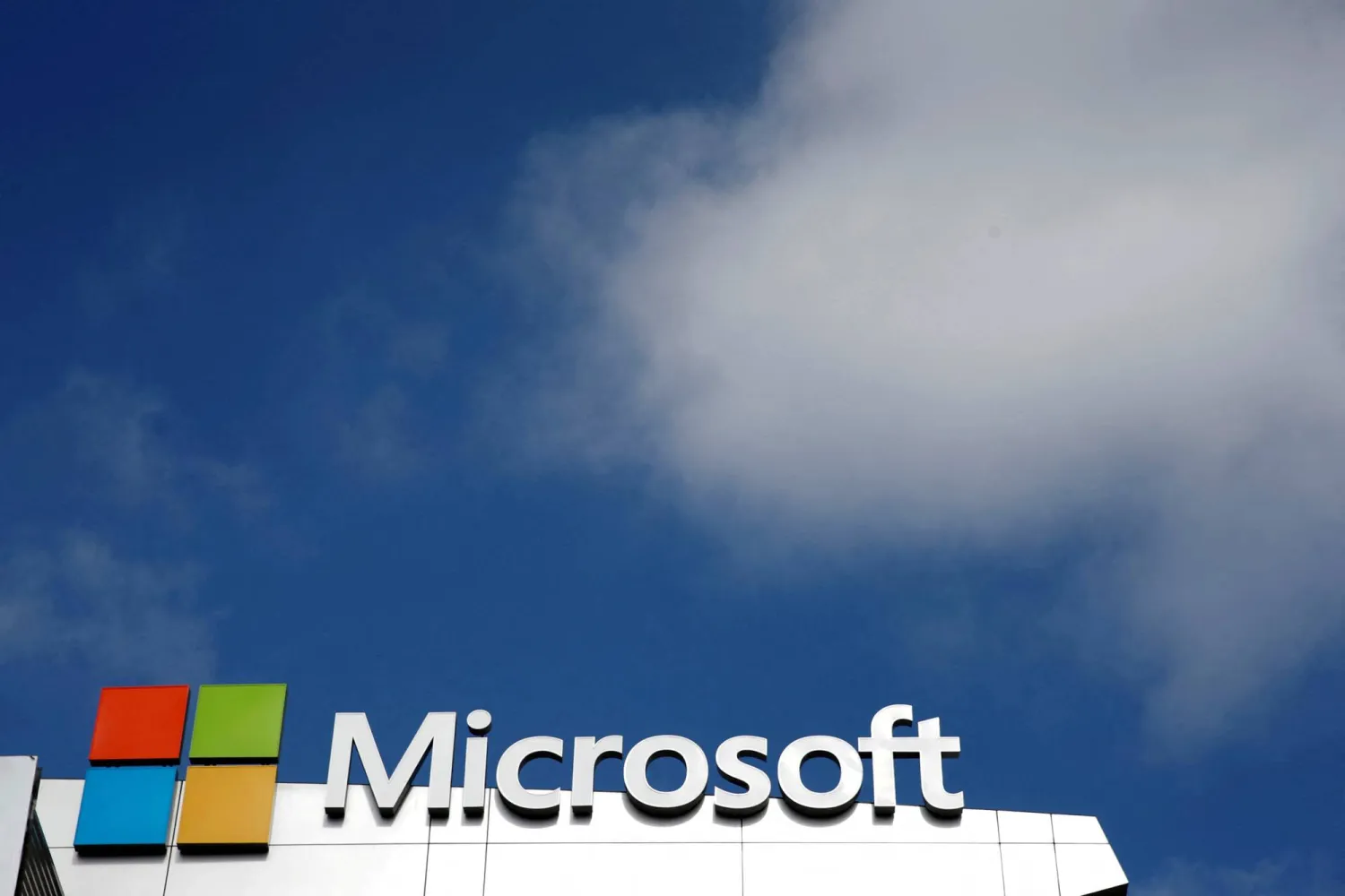 FILE PHOTO: A Microsoft logo is seen next to a cloud in Los Angeles, California, US June 14, 2016. REUTERS/Lucy Nicholson/File Photo