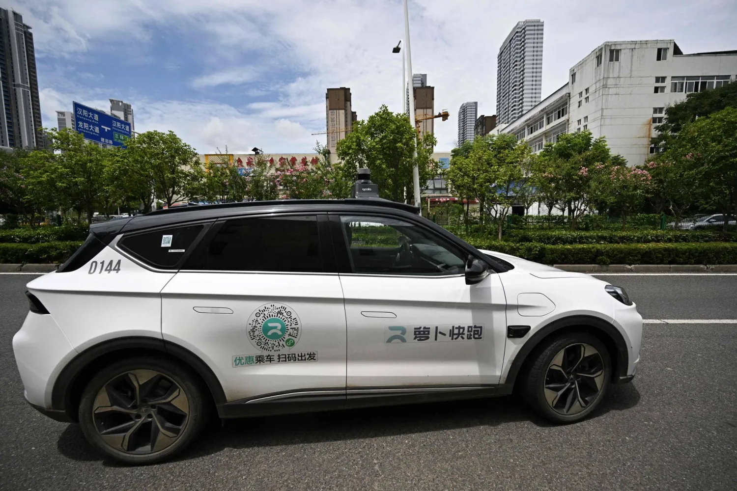This file photo taken on August 1, 2024 shows a general view of a driverless robotaxi autonomous vehicle developed as part of tech giant Baidu's Apollo Go self-driving project, in Wuhan, in central China's Hubei province. (Photo by PEDRO PARDO / AFP)