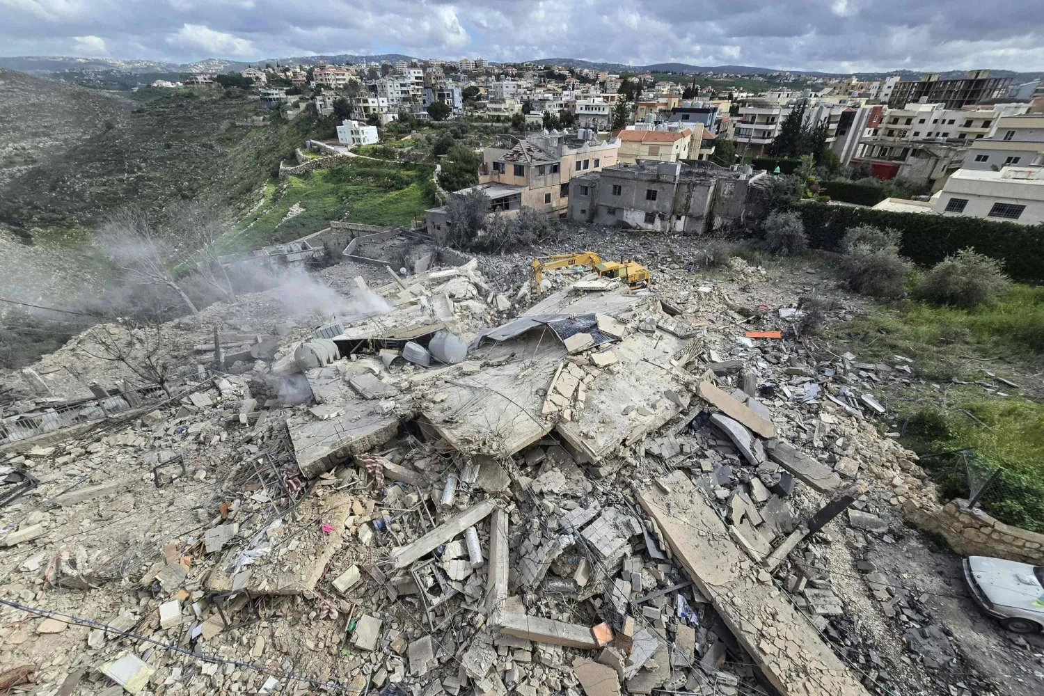 First responders clear the rubble from the site of an Israeli airstrike that targeted a building in the southern Lebanese village of Hanouiyeh, east of Tyre, on March 30, 2026. (AFP)