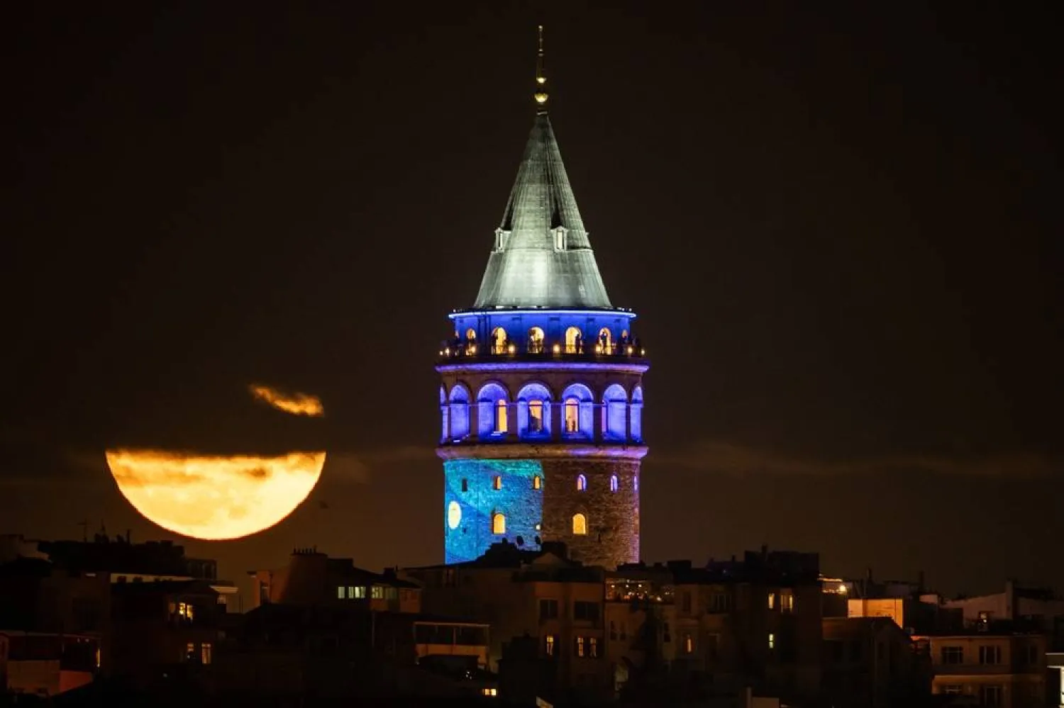 A full moon rises behind Galata Tower, in Istanbul, Türkiye, Thursday, April 2, 2026. (AP) 