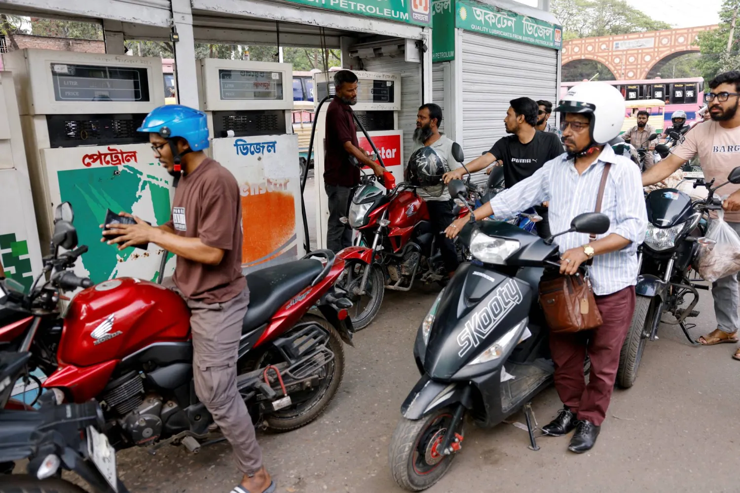 Motorcyclists queue to refuel at a fuel station, as concerns grow over fuel supply amid fhe US-Israel conflict with Iran, in Dhaka, Bangladesh, March 15, 2026. (Reuters) 