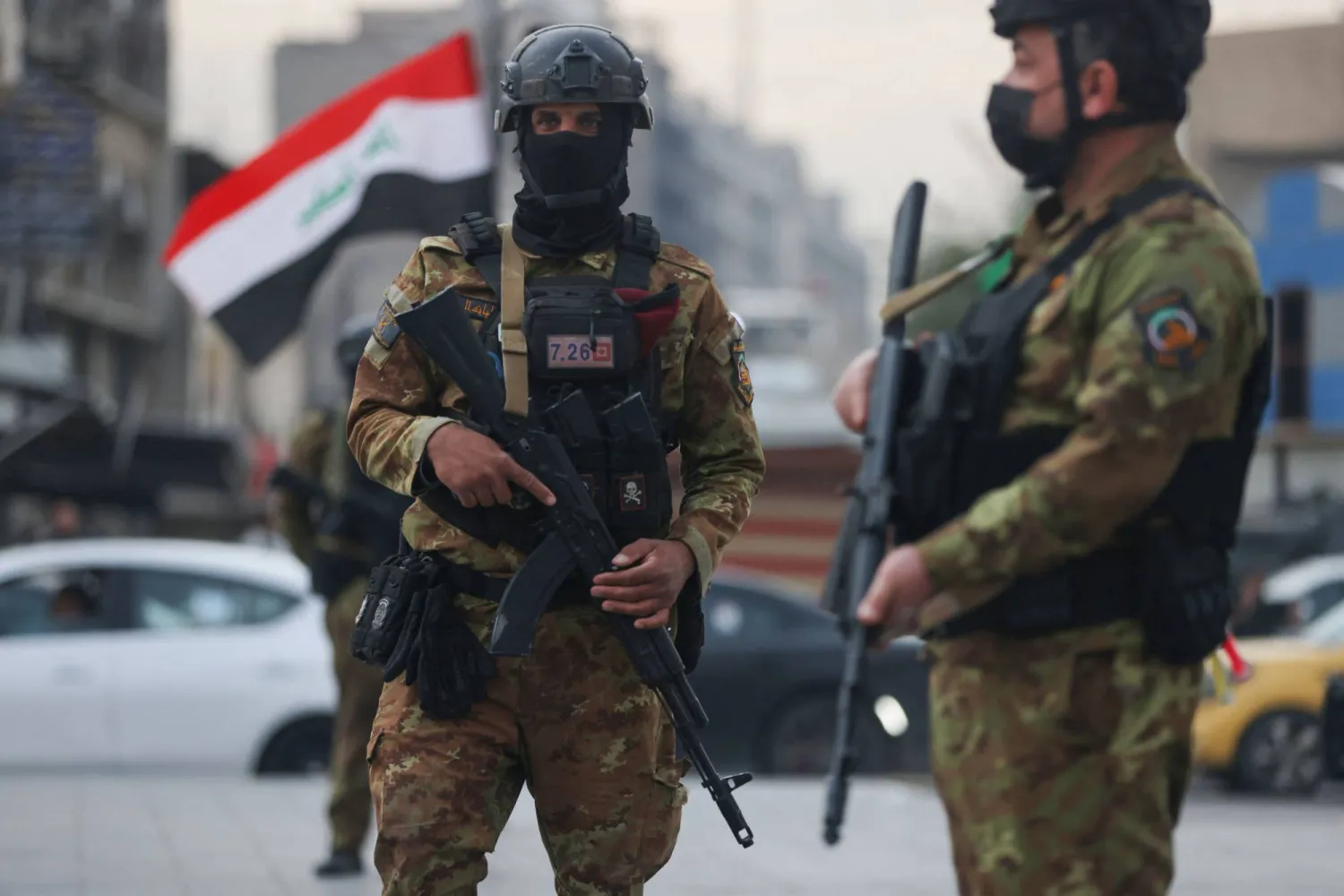 Members of Iraq's Hashed al-Shaabi forces stand guard during a pro-Iran rally in Tahrir Square in Baghdad on April 2, 2026.  (Photo by AHMAD AL-RUBAYE / AFP)