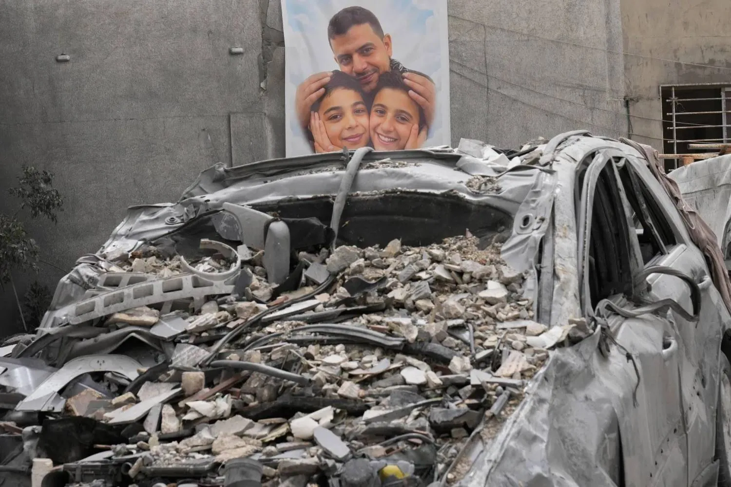 A poster of a man and two children killed in an Israeli air strike that targeted their home in south Lebanon (AP) 