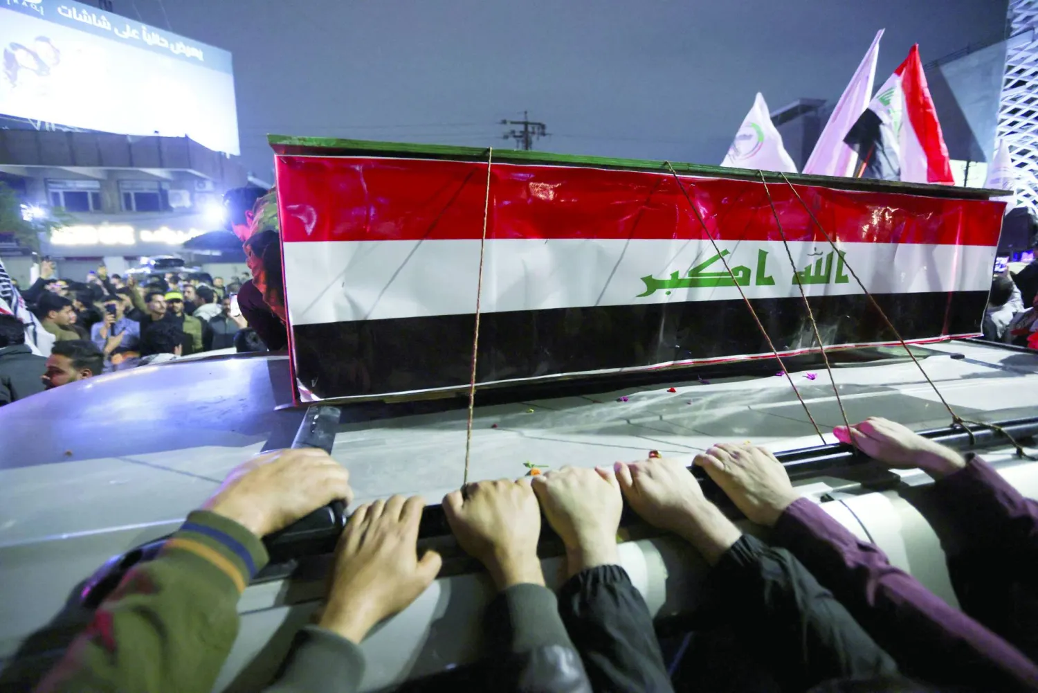 Mourners attend the funeral of members of Iraq's Hashed al-Shaabi, who were killed in an airstrike in the town of al‑Qaim near the Syrian border, amid heightened regional tensions due to the US-Israel conflict with Iran, in Baghdad, Iraq, March 12, 2026. REUTERS/Stringer