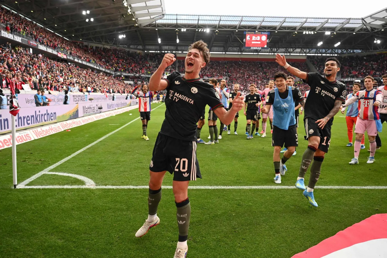 Bayern Munich players including Bayern Munich's German midfielder #20 Tom Bischof and Bayern Munich's Colombian forward #14 Luis Diaz (R) celebrate after the German first division Bundesliga football match between SC Freiburg and FC Bayern Munich in Freiburg, southern Germany on April 4, 2026. (AFP)