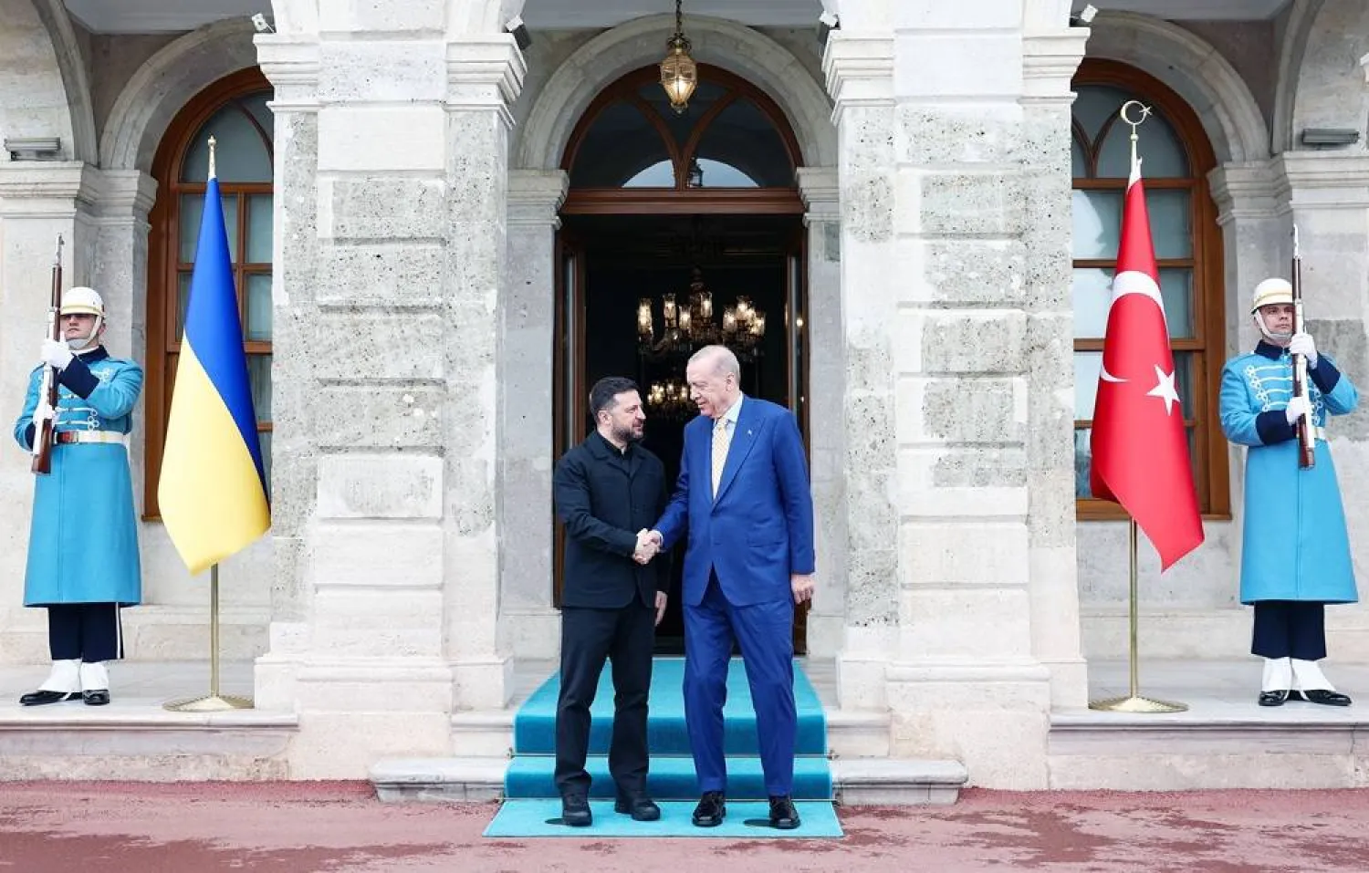 This handout photograph taken and released by the Turkish presidential press service on April 4, 2026, shows Türkiye's President Recep Tayyip Erdogan (R) welcoming and shaking hands Ukraine's President Volodymyr Zelensky (L) upon arrival for a bilateral meeting on security at Dolmabahce Presidential Office, in Istanbul. (Turkish Presidential Press Service / AFP) 