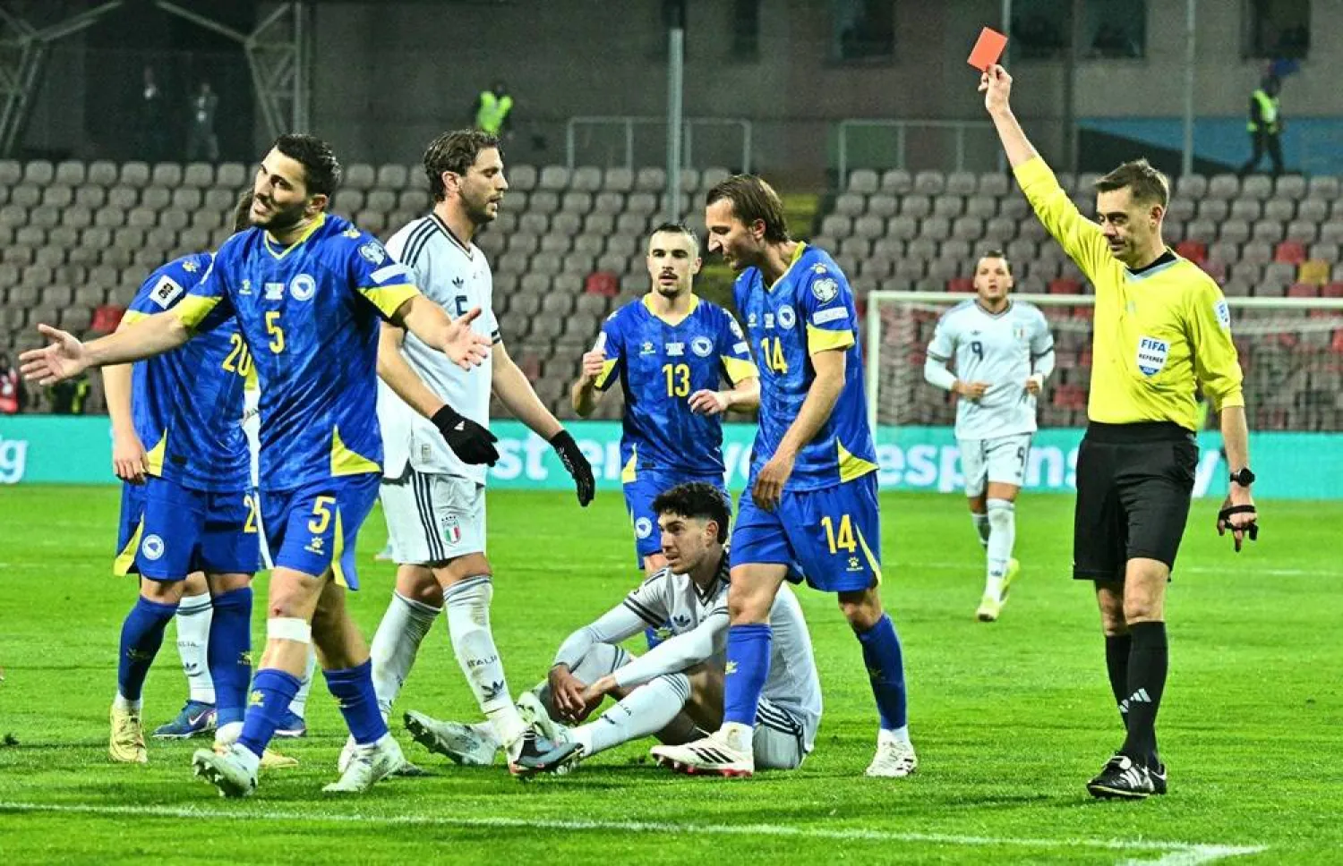 Italy's defender #21 Alessandro Bastoni (C, bottom) receives a red card from French referee Clement Turpin during the FIFA World Cup 2026 European qualification final football match between Bosnia-Herzegovina and Italy at the Bilino-Polje stadium in Zenica on March 31, 2026. (AFP) 