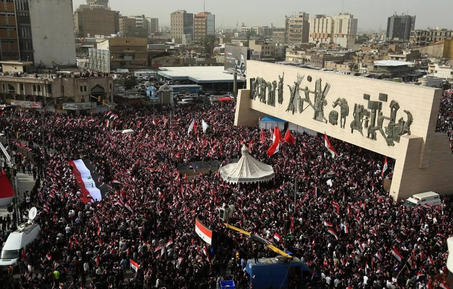 Followers of Iraq's Moqtada al-Sadr wave Iraqi national flags during a protest against the joint US-Israeli strikes on Iran, as they gather in Tahrir Square, Baghdad, Iraq, 04 April 2026. (EPA)