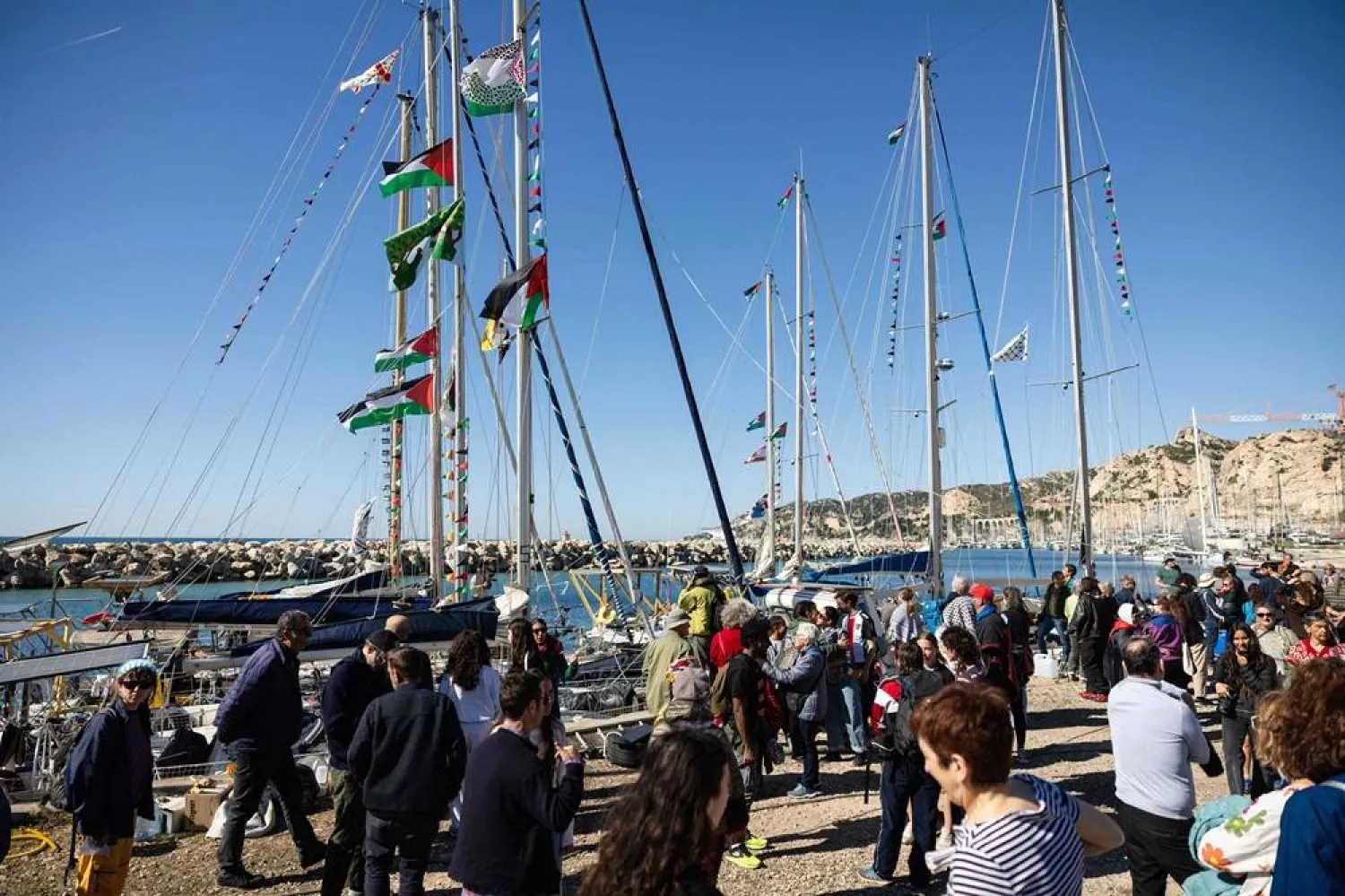 Activists gather in l'Estaque, part of Marseille's harbor, southern France, on April 4, 2026, during a rally in support of a flotilla carrying activists from “Thousand Madleens to Gaza” movement as they prepare to set sail. (AFP) 