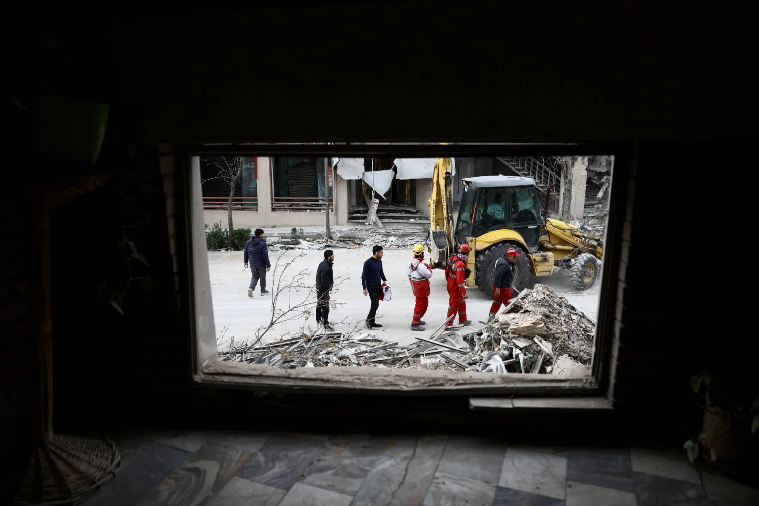 رجال الإنقاذ في موقع غارة استهدفت العاصمة الإيرانية طهران (رويترز)