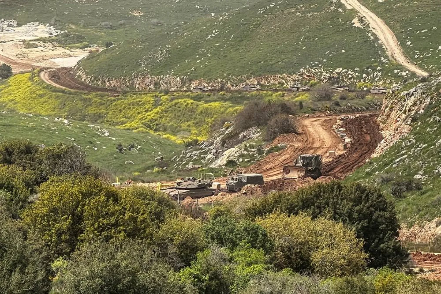 Israeli military vehicles drive through mud on the Lebanese side of the Israel-Lebanon border, after Israeli forces launched a campaign against Iran-backed Hezbollah in southern Lebanon, amid the US-Israeli conflict with Iran, as seen from northern Israel April 4, 2026. (Reuters) 