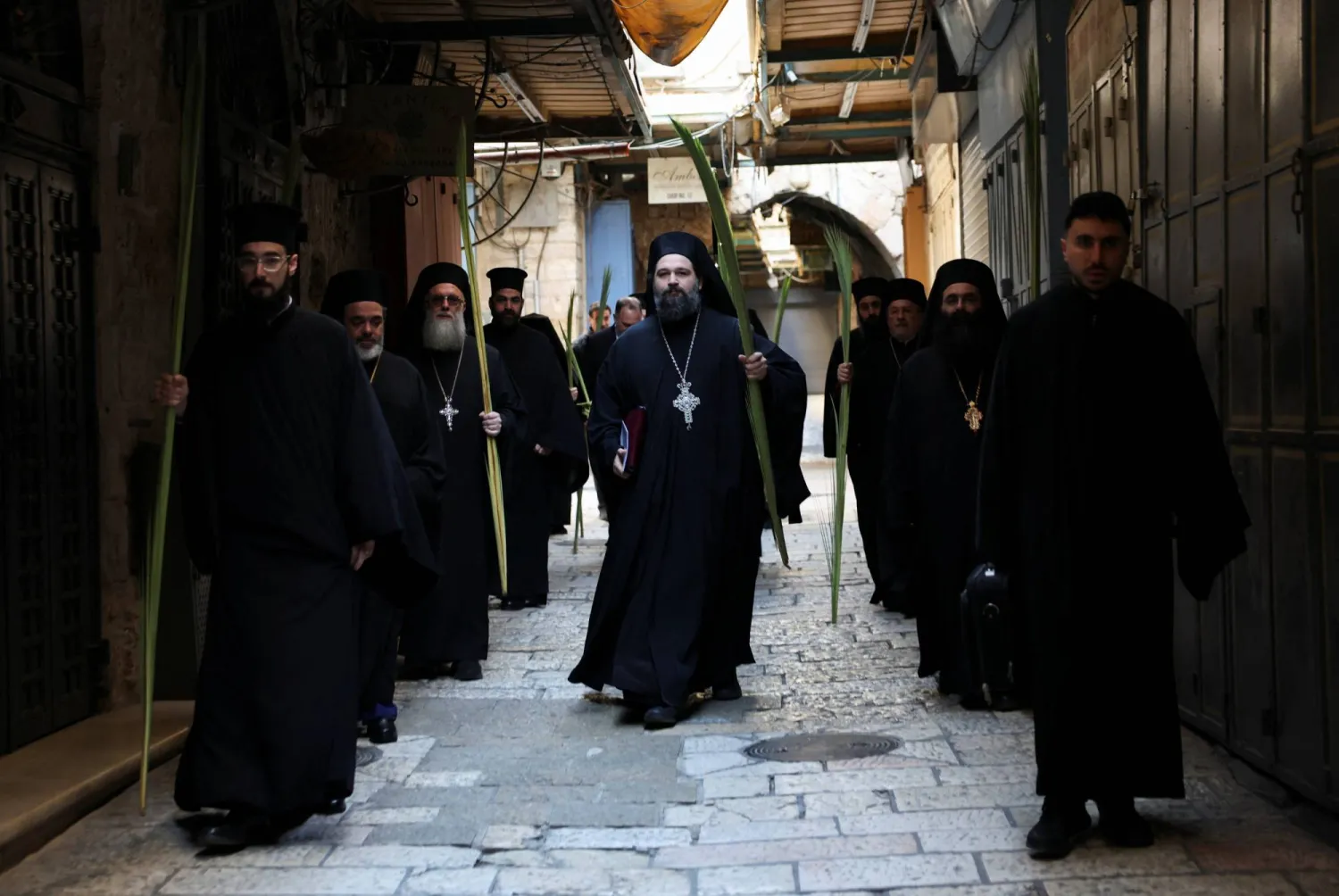  Members of the clergy make their way to the Church of the Holy Sepulchre for prayers on Palm Sunday, following restrictions on gatherings in large groups, amid the US-Israel conflict with Iran, in Jerusalem's Old City April 5, 2026. (Reuters)
