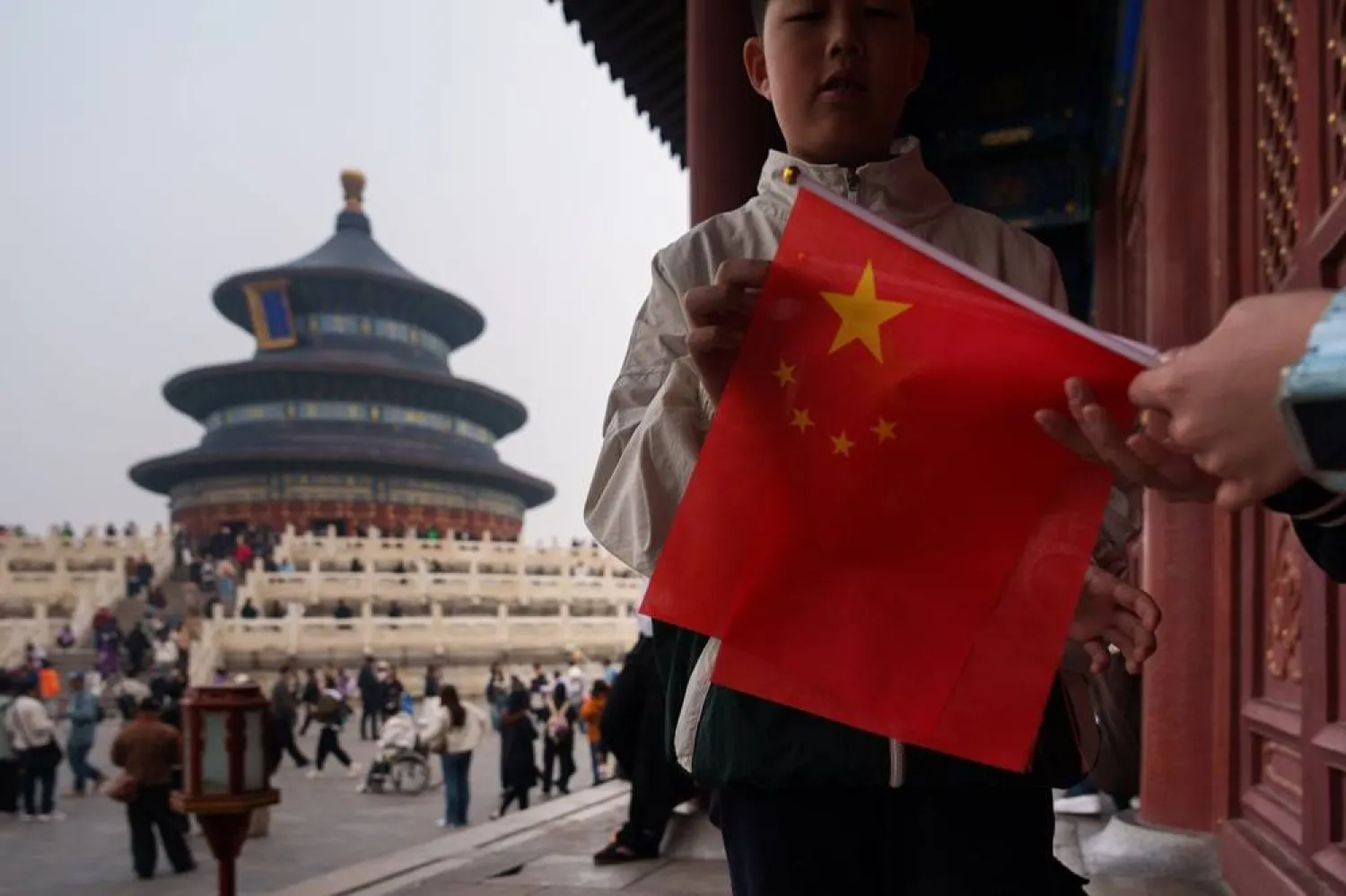  A child holds a Chinese national flag near the Hall of Prayer for Good Harvests in Beijing, China, Friday, April 3, 2026. (AP) 