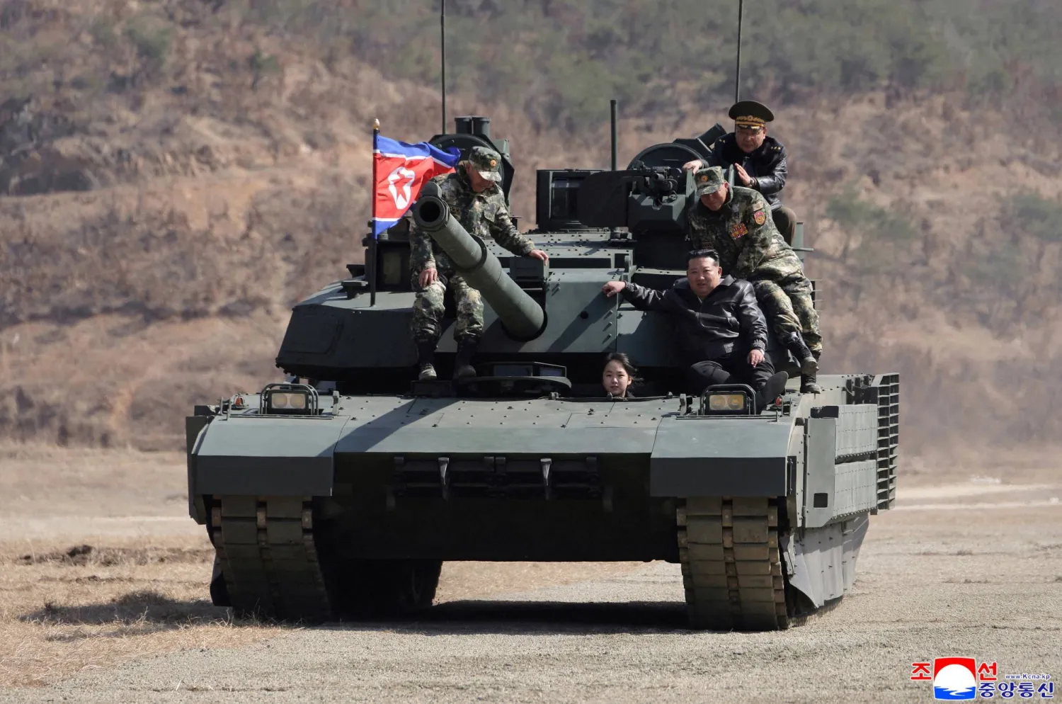 North Korean leader Kim Jong Un and his daughter Kim Ju Ae ride a tank during what North Korean state news agency KCNA reports is an offensive tactical drill involving a new type of tank, at a training base in Pyongyang, North Korea, March 19, 2026, in this picture released by North Korea's official Korean Central News Agency. (KCNA via Reuters)