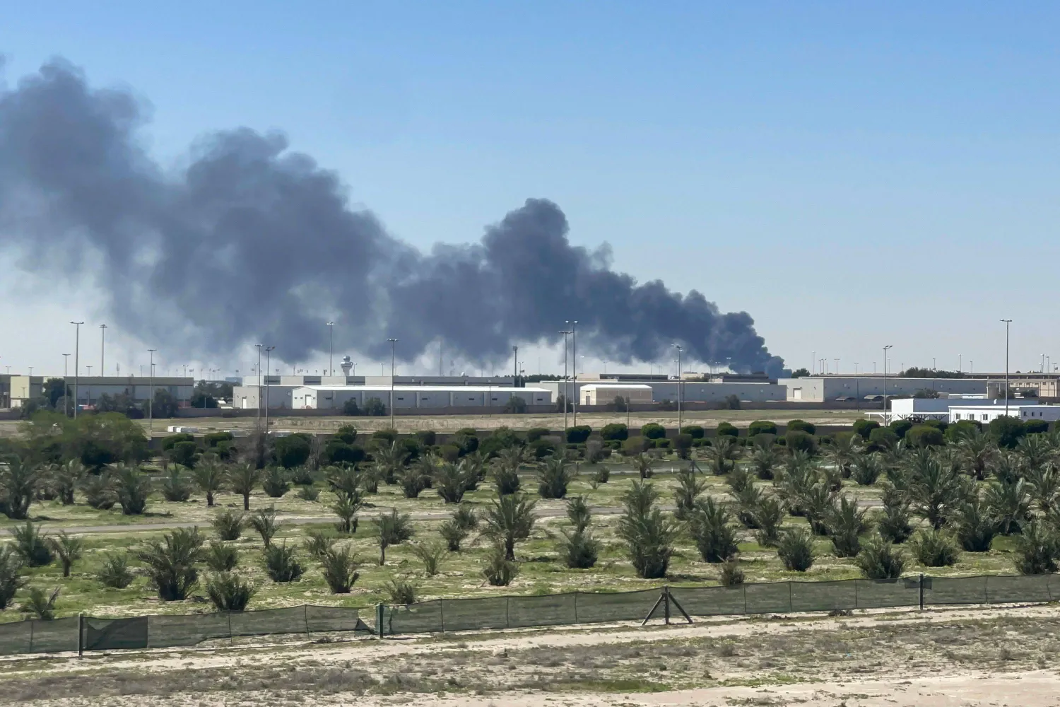 Smoke rises from an area of Kuwait's international airport after a reported drone strike on April 1, 2026. (Photo by AFP)